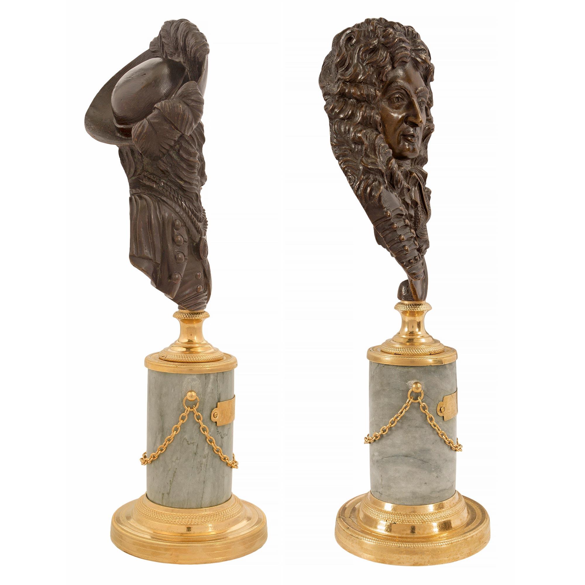 A fine pair of French 19th century Louis XVI st. patinated bronze, ormolu and Gris St. Anne marble statuettes of Nicolas Catinat and the Count of Tourville, both Marshals of France. Each statue is raised by a circular mottled ormolu base with