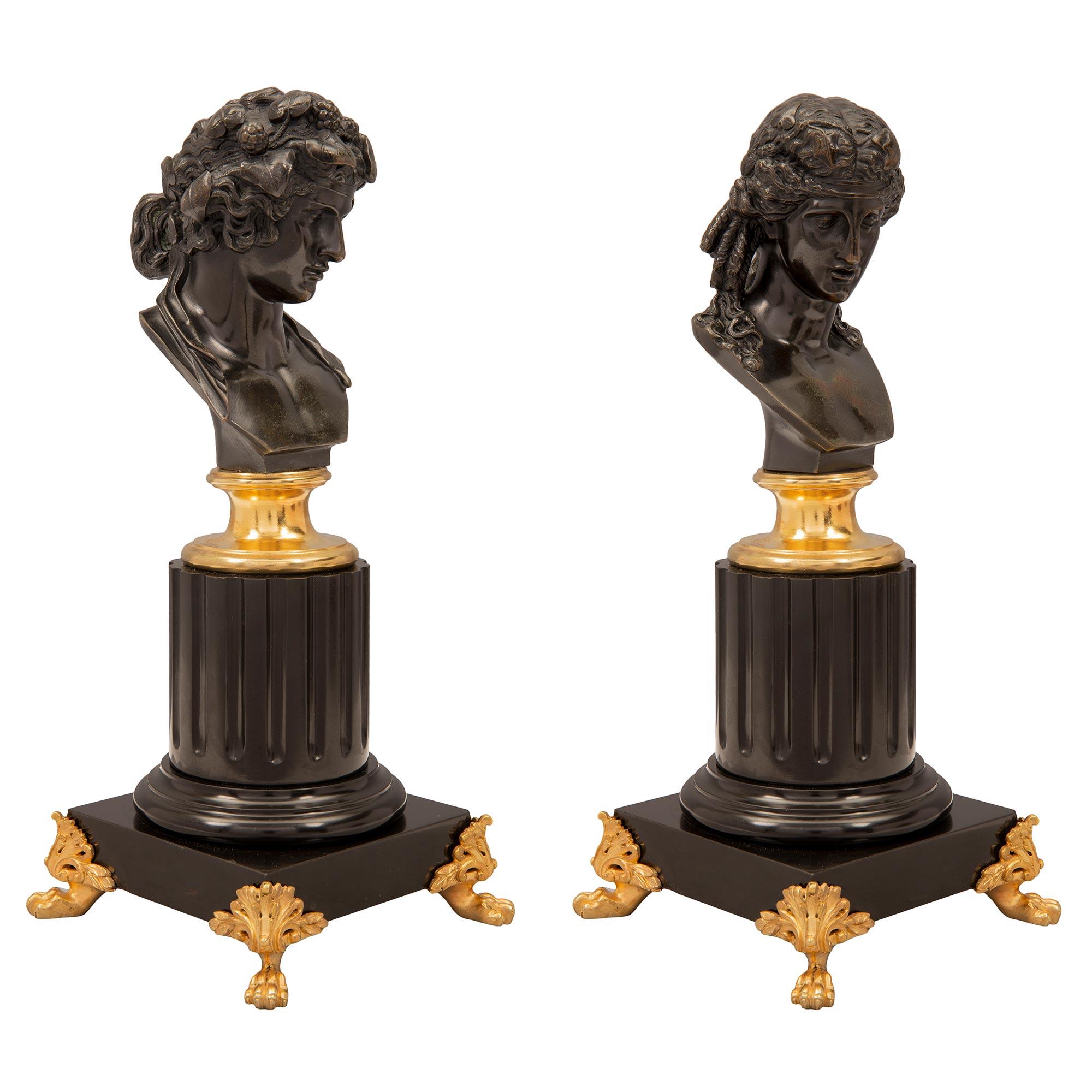 An exceptional true pair of French 19th century Louis XVI st. patinated bronze, ormolu and Black Belgian marble statuettes of Apollo and Daphne. Each small scale statue is raised by pierced ormolu supports with handsome paw feet and palmettes. Above