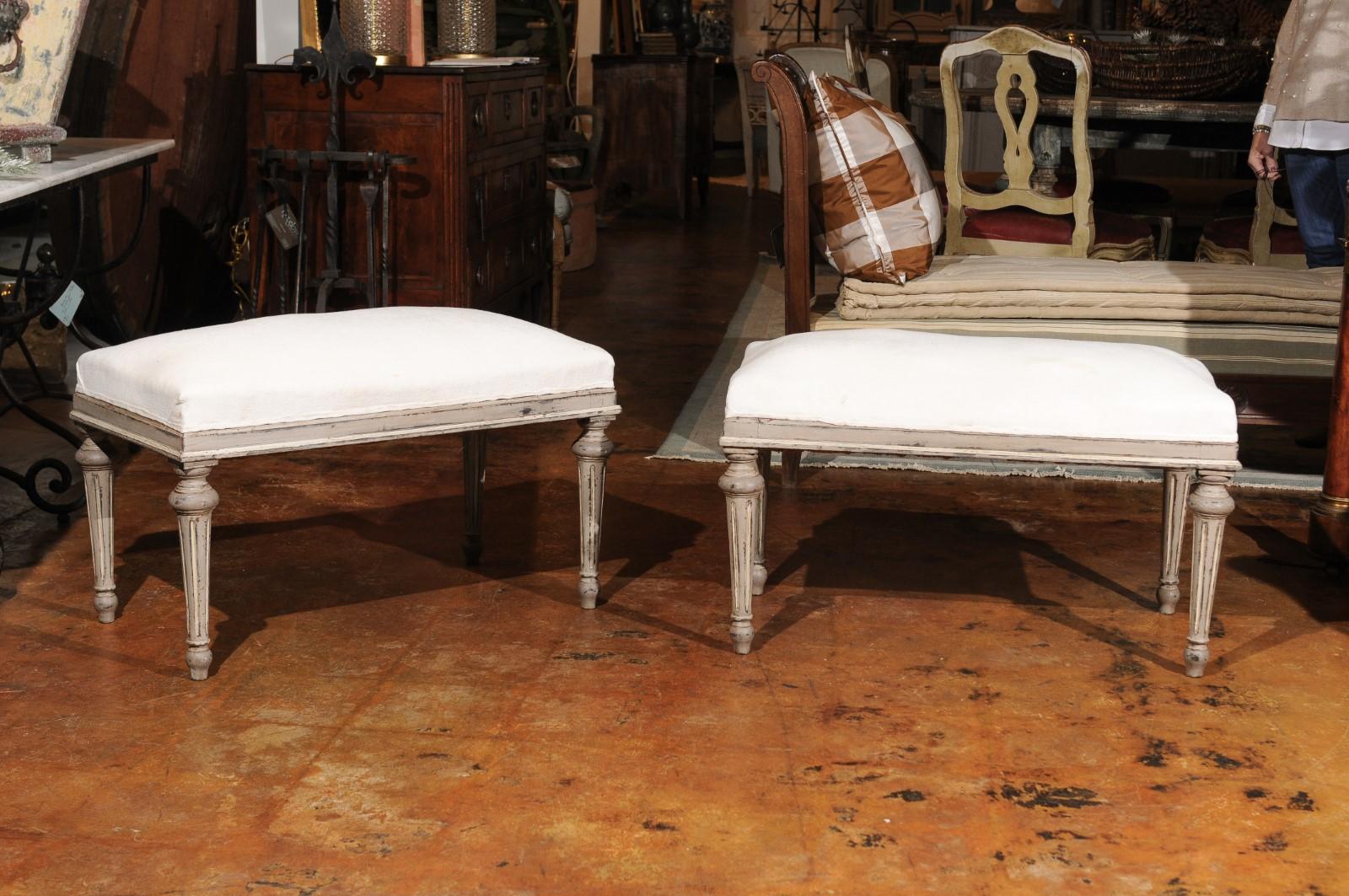  French Louis XVI style hand painted bench from the 19th century, with fluted legs. This  French 19th century bench features the stylistic characteristics of the Louis XVI period. The bench presents a rectangular seat covered with a simple muslin