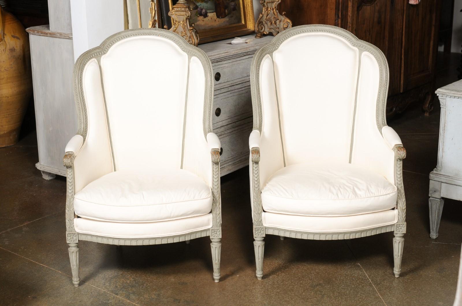 Carved Pair of French 19th Century Louis XVI Style Painted Bergères with Upholstery For Sale