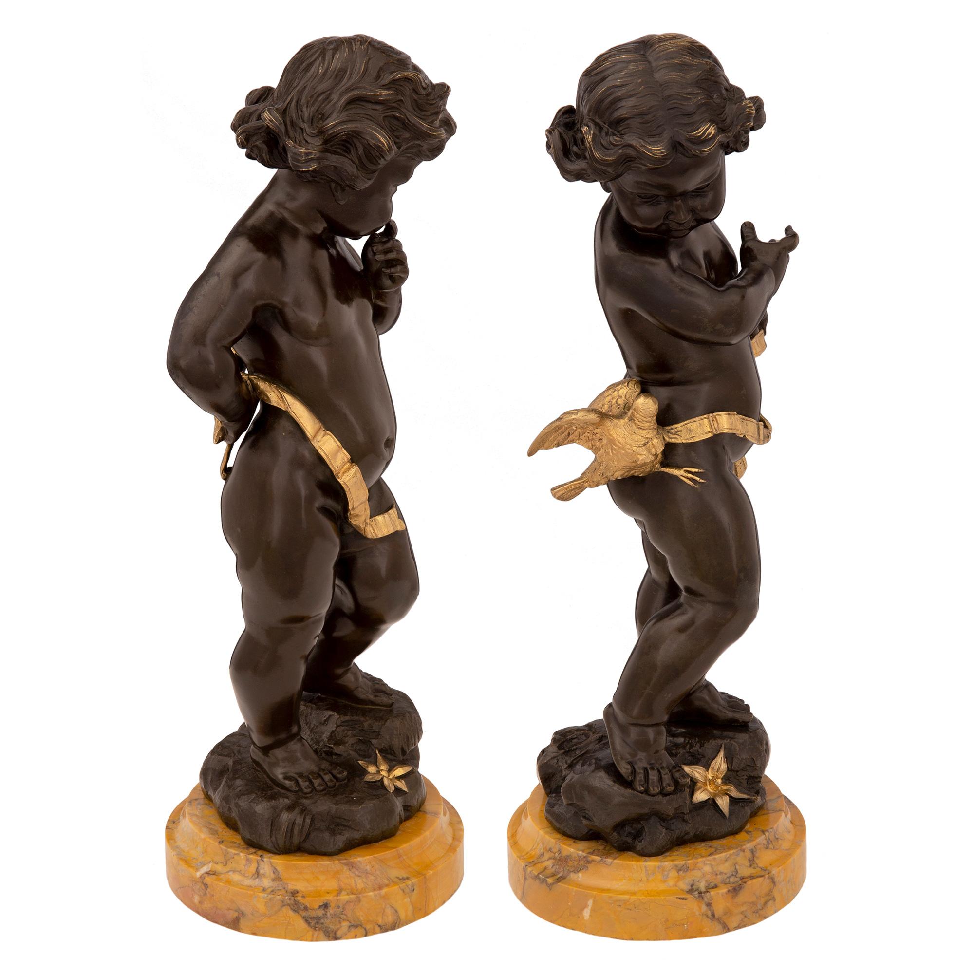 A most elegant and high quality true pair of French 19th century Louis XVI st. patinated bronze, ormolu and Sienna marble statues. Each beautiful statue is raised by a circular Sienna marble base with a fine mottled border. The lovely richly chased
