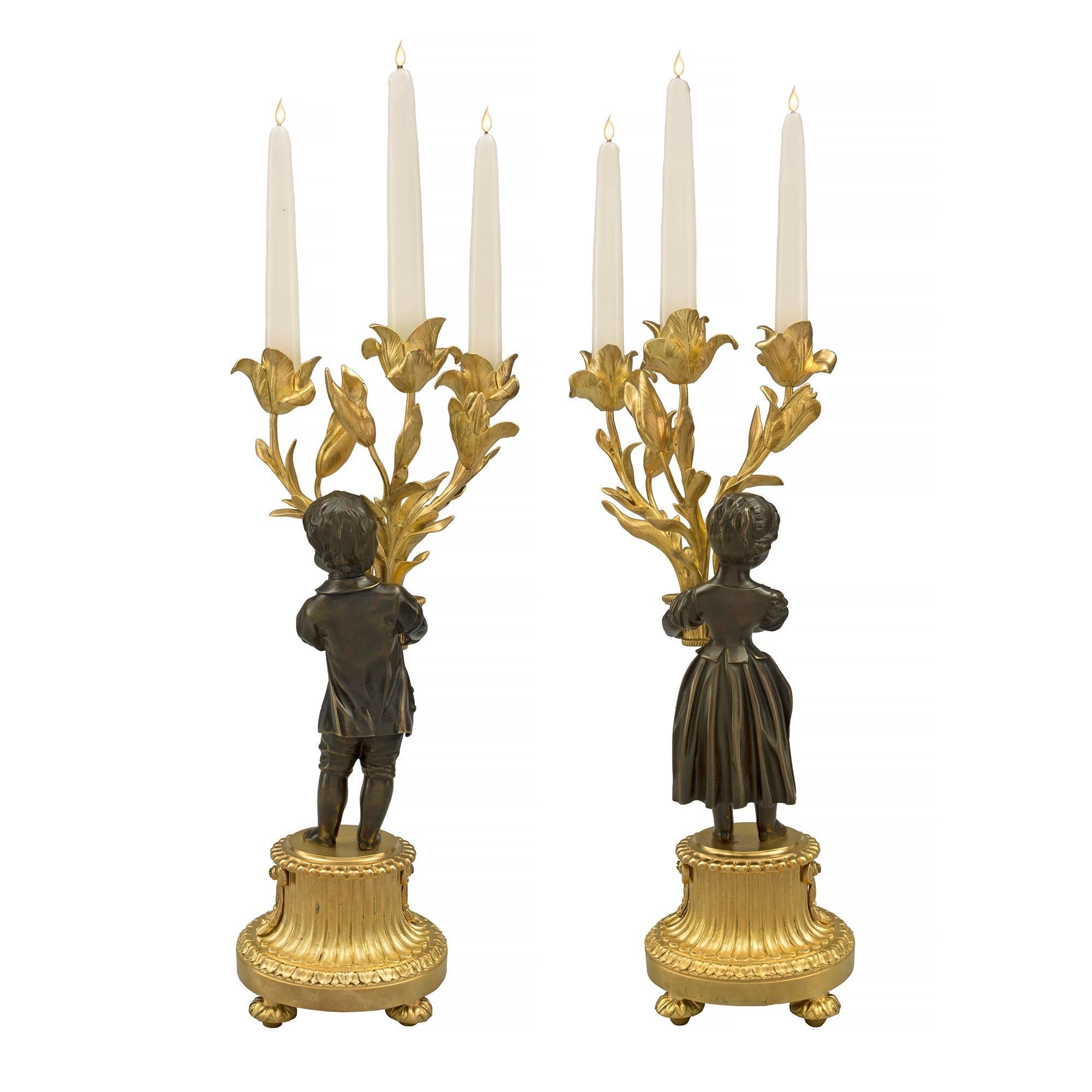 Patinated Pair of French 19th Century Louis XVI Style Three-Arm Candelabras For Sale