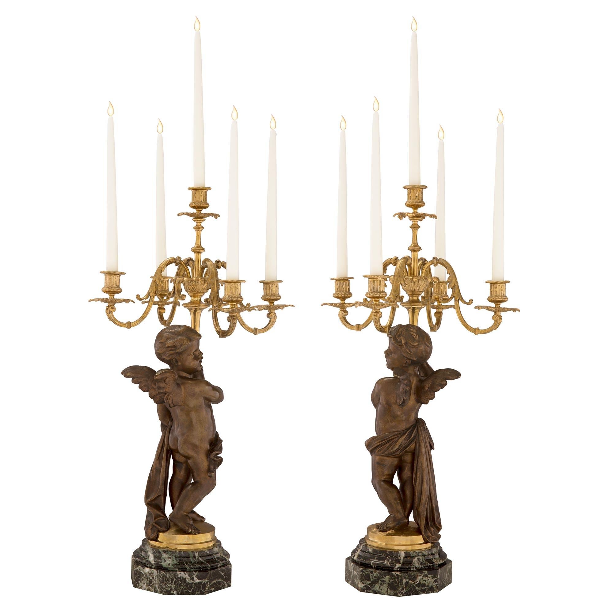 An impressive and most elegant true pair of French mid 19th century Louis XVI st. ormolu, patinated bronze, Vert Antique marble candelabras. Each candelabra is raised by an octagonal shaped Vert Antique marble base with a lovely and most decorative