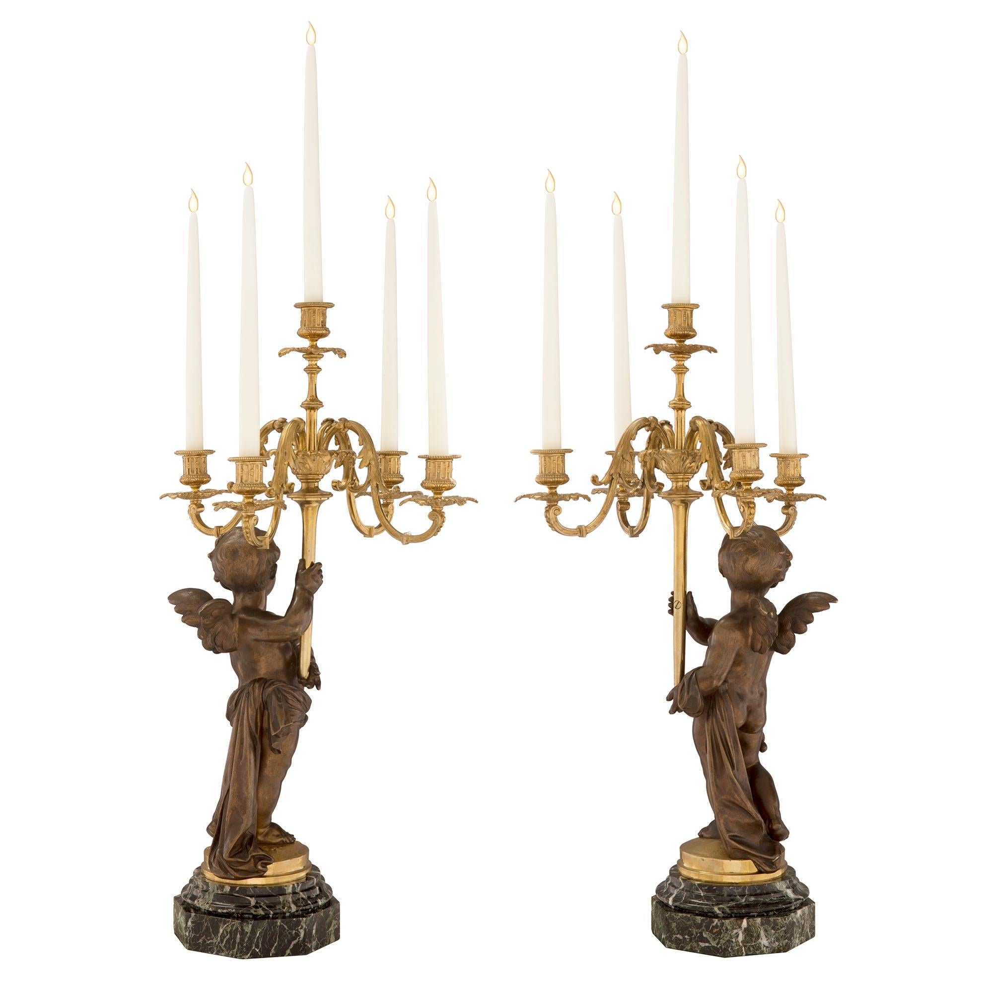 Patinated Pair of French 19th Century Louis XVI Style Winged Cherub Candelabras For Sale