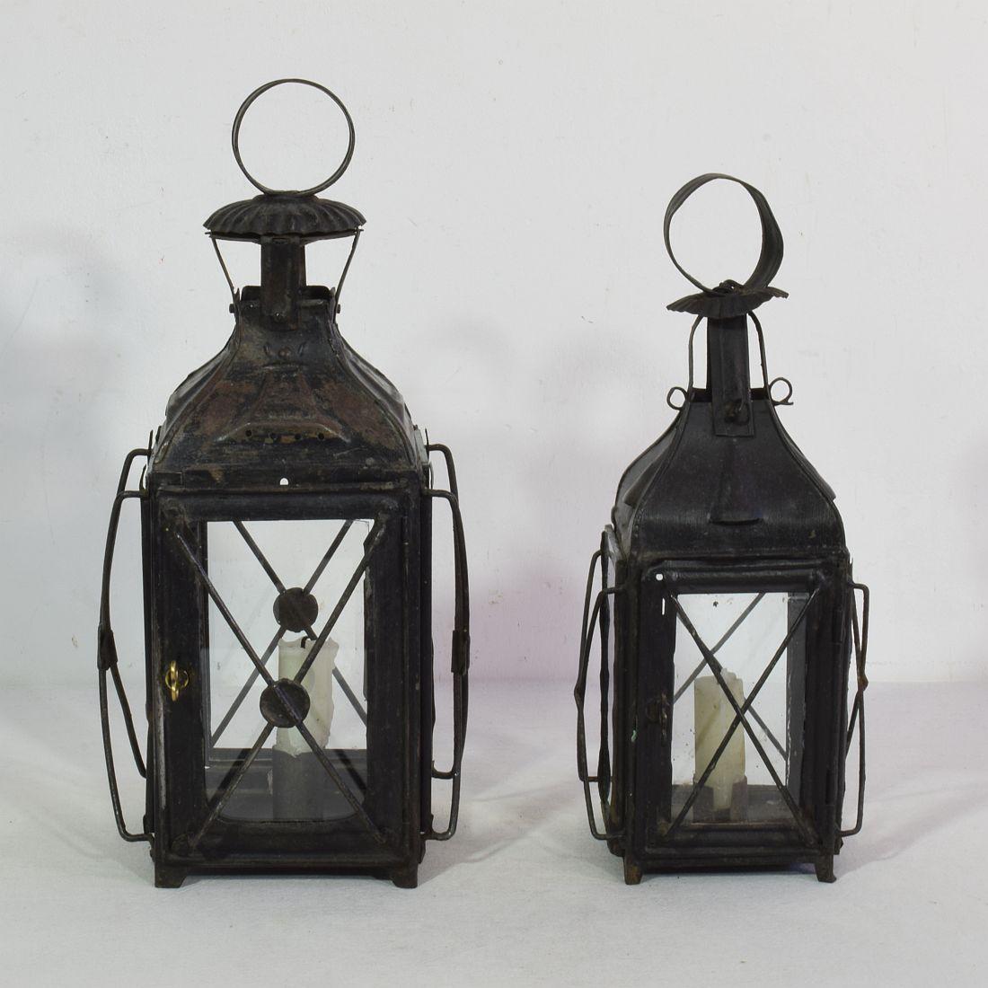Nice pair of metal lanterns, France, circa 1850-1900.
Weathered and old repairs ( glass once replaced )
Measures: H:28-32cm  W:12-15cm D:12-15cm 
Measurement here below of the largest lantern.