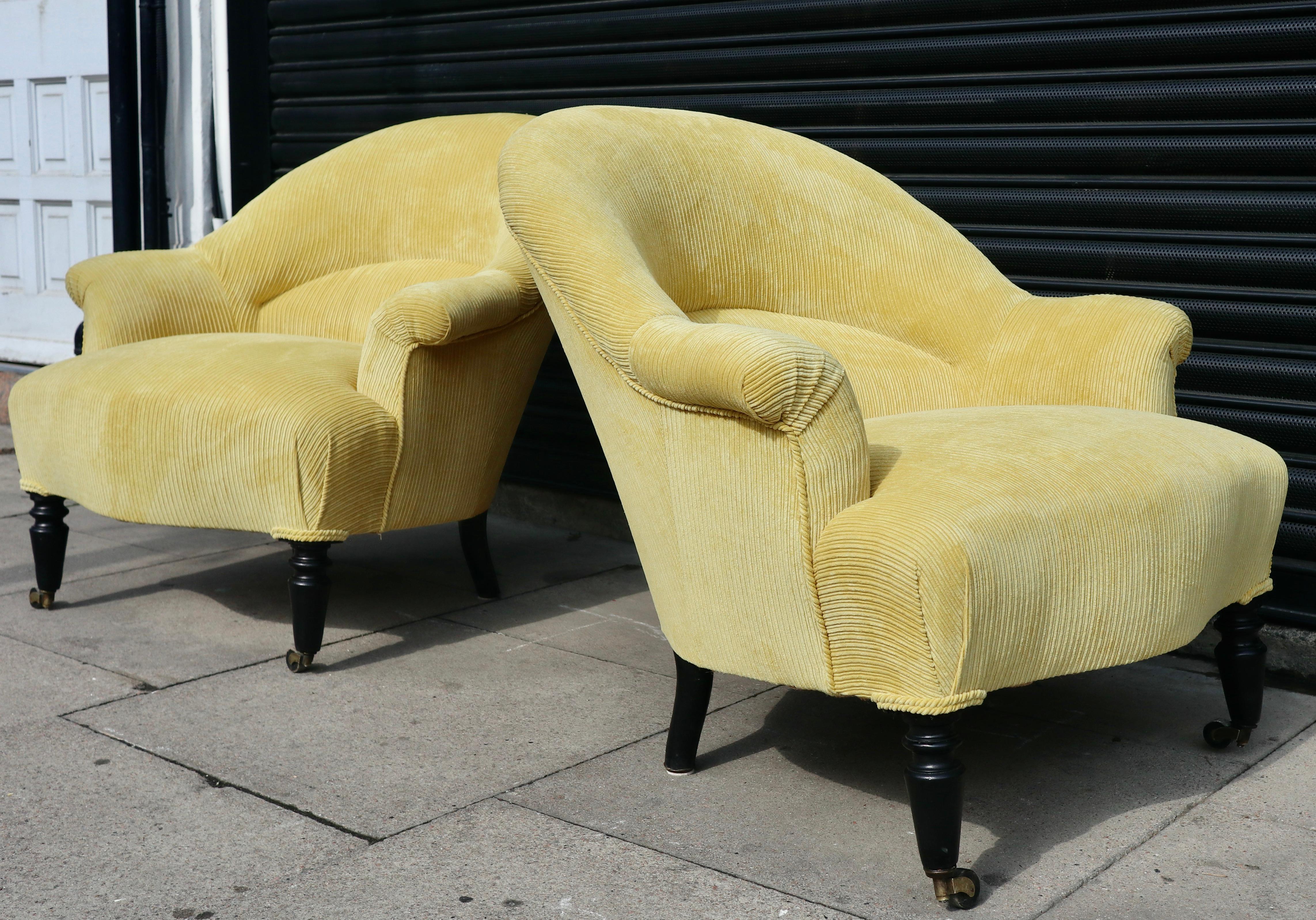 A very beautiful, stylish and extremely comfortable pair of original antique 19th century French, Napoleon III crapaud armchairs.  Reupholstered in yellow coloured 100% cotton corduroy textile on stained carved beech legs on castors. These chairs