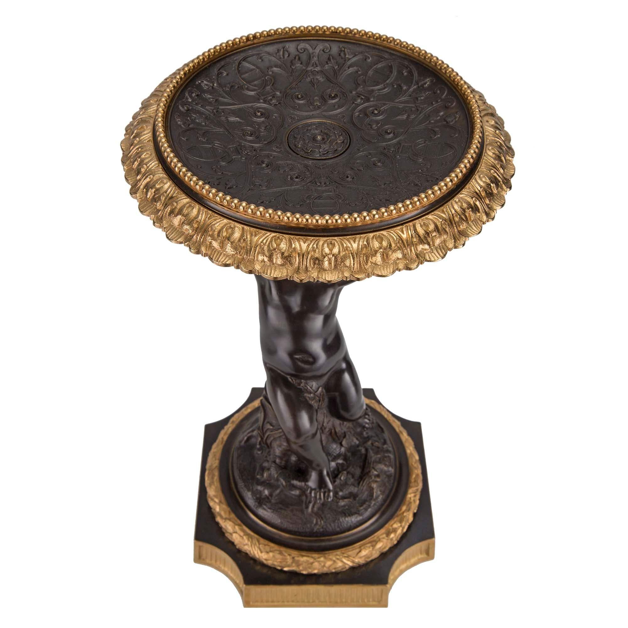 A wonderful and charming true pair of French 19th century Napoleon III st. patinated bronze and ormolu tazzas. Each tazza is raised by a square ormolu base with concave corners and a recessed reeded pattern below a decorative tied berried laurel