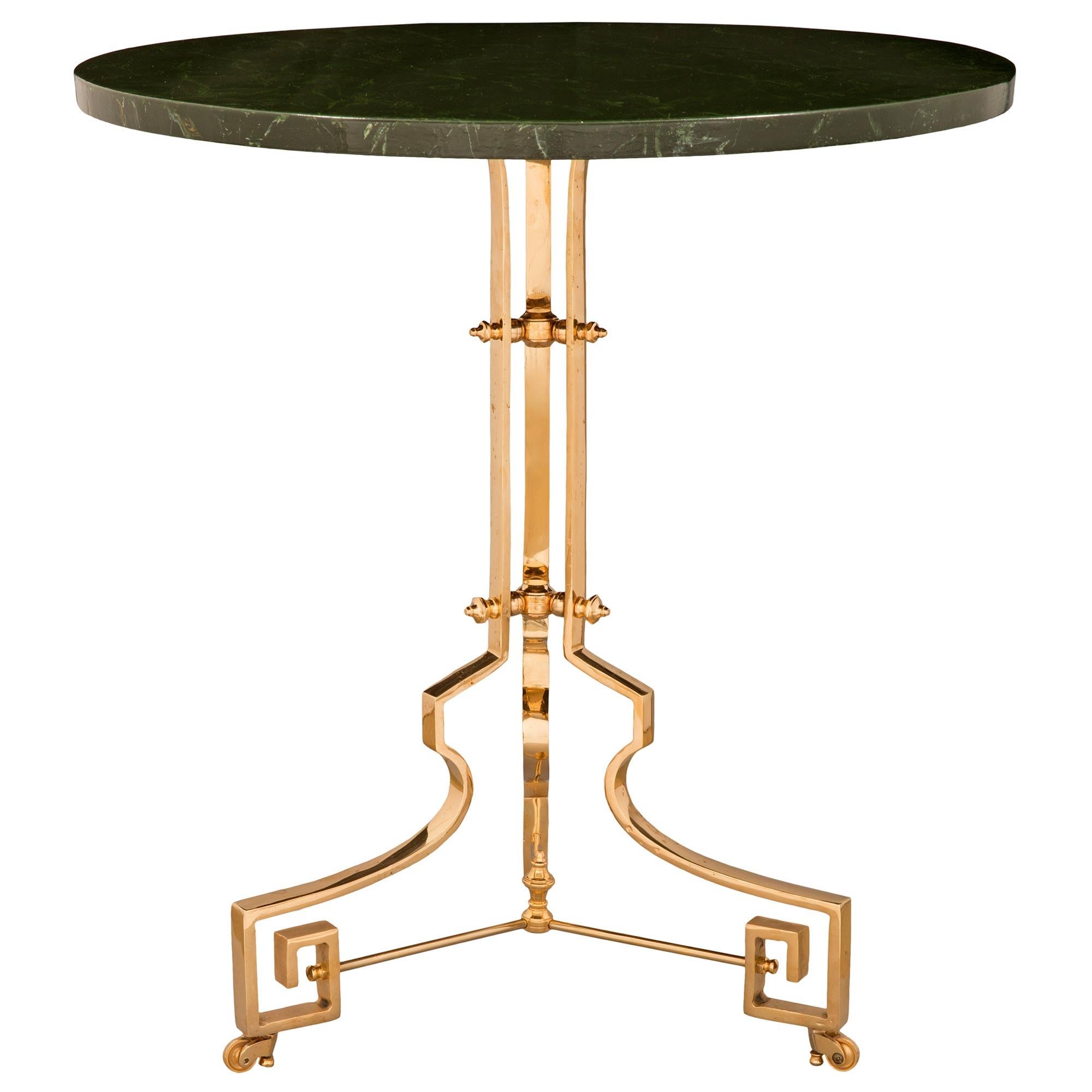 A unique and exceptionally decorative pair of French 19th century Neo-Classical st. ormolu and faux painted marble tilt top side tables. The tables are raised by superb Greek key shaped feet above their original casters leading up to the beautiful