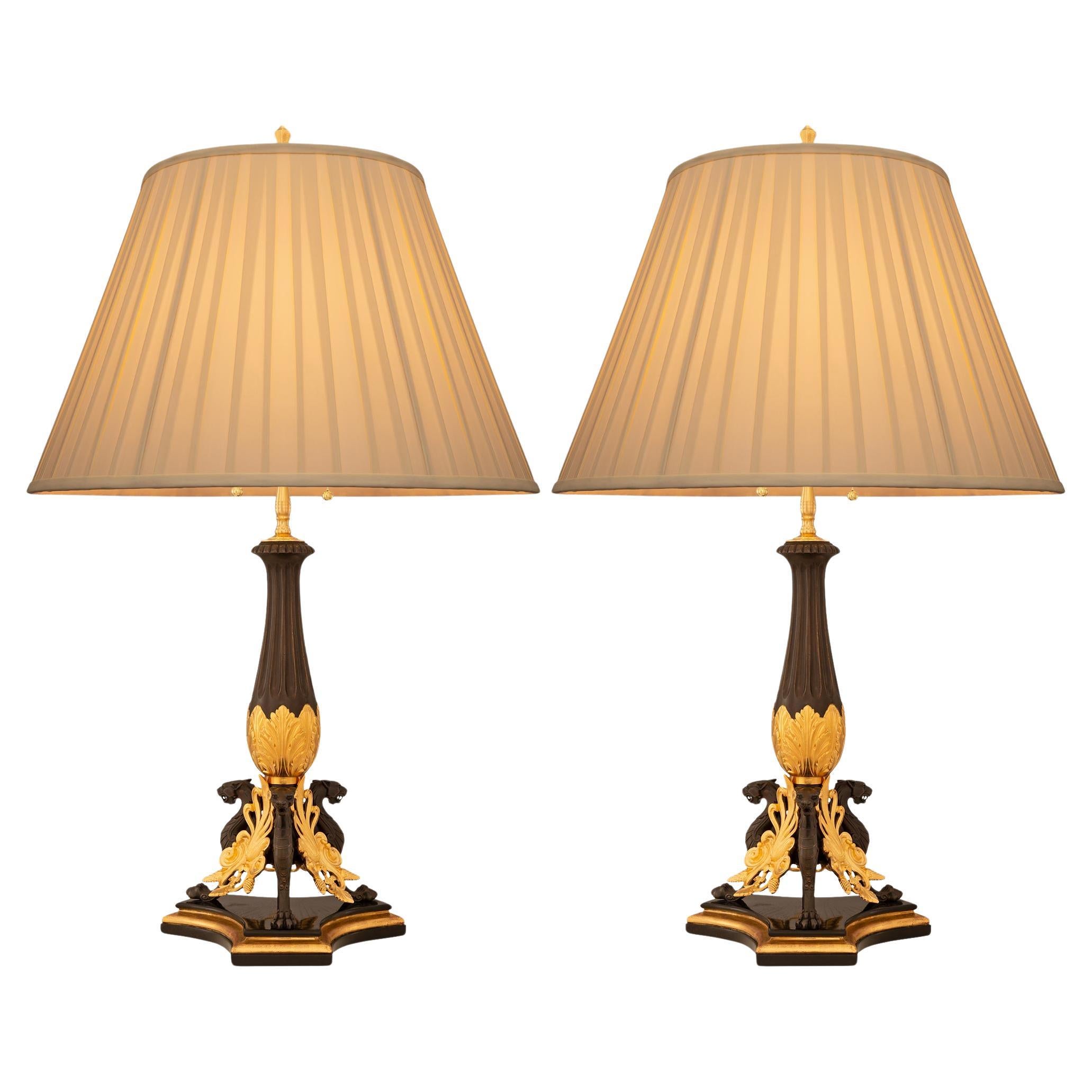 pair of French 19th century Neo-Greek st. Giltwood, Bronze and Ormolu lamps