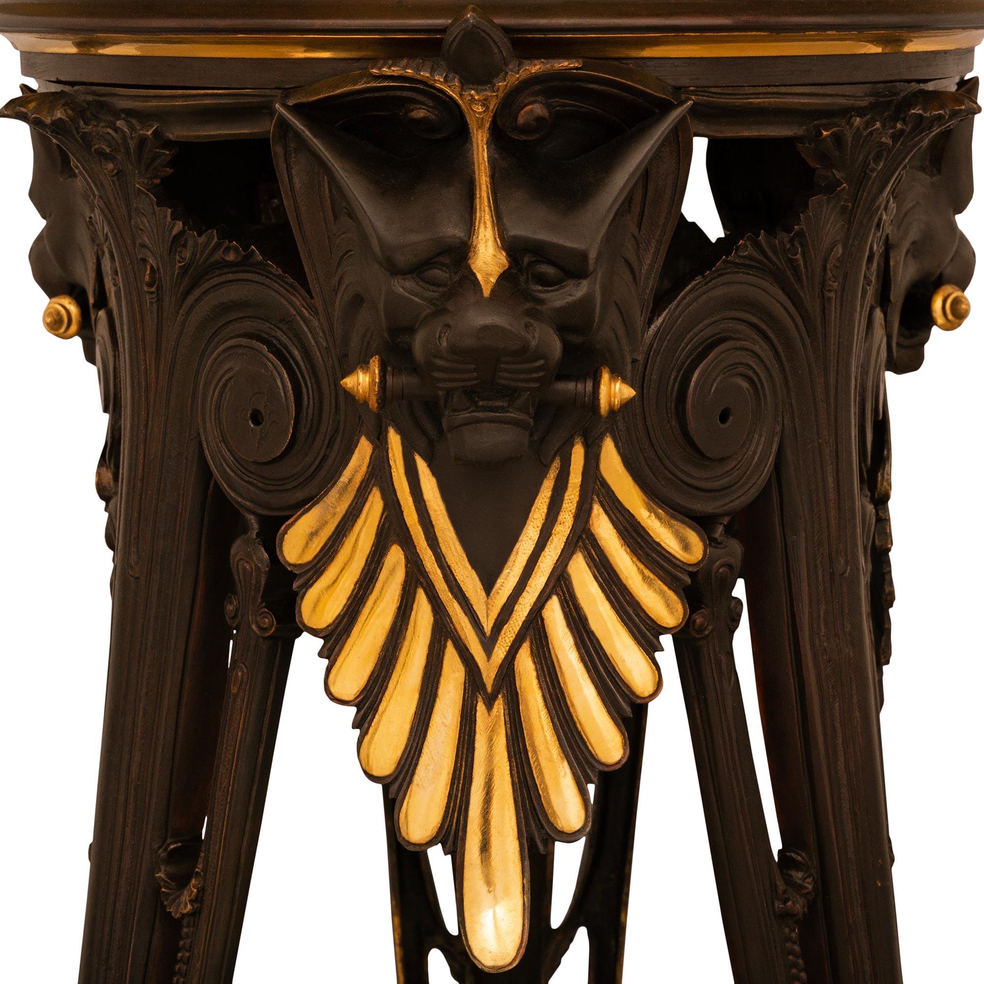 A most impressive pair of French 19th century Neo-Greek st. Ormolu and patinated Bronze pedestals, attributed to G. Servant, France, Circa 1880. Each handsome pedestal is raised by three pierced straight patinated Bronze legs above cabriole shaped