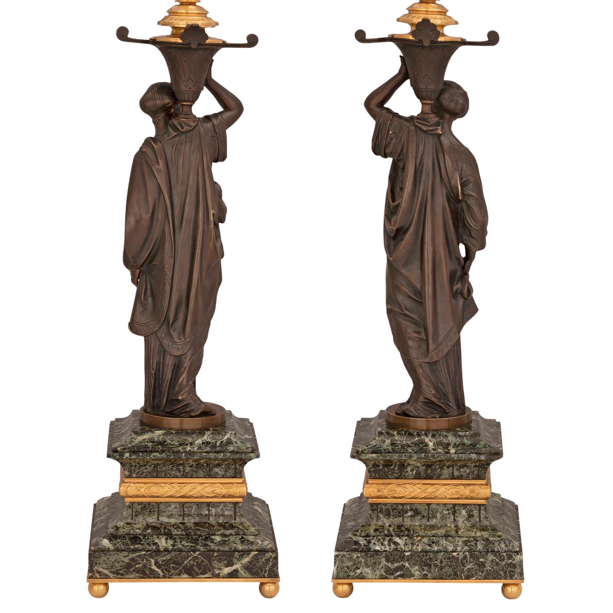 A most elegant and high quality true pair of French 19th century Neo-Classical st. patinated bronze, ormolu and Vert de Patricia marble lamps. Each lamp is raised by four fine ball shaped ormolu feet below the striking square Vert de Patricia marble