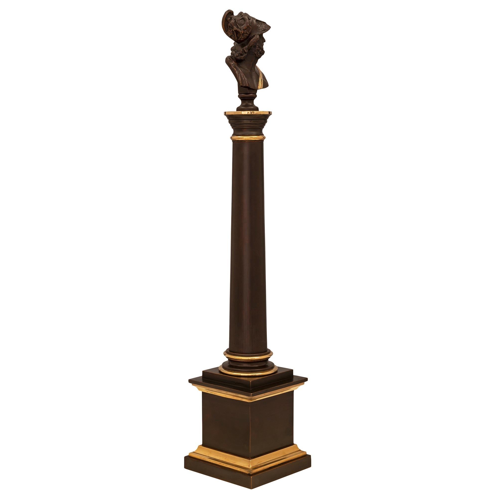 An attractive and most decorative true pair of French 19th century Neoclassical st. Grand Tour patinated bronze and ormolu columns. Each column is raised by an elegant square base with a beautiful mottled stepped design and ormolu accents. The