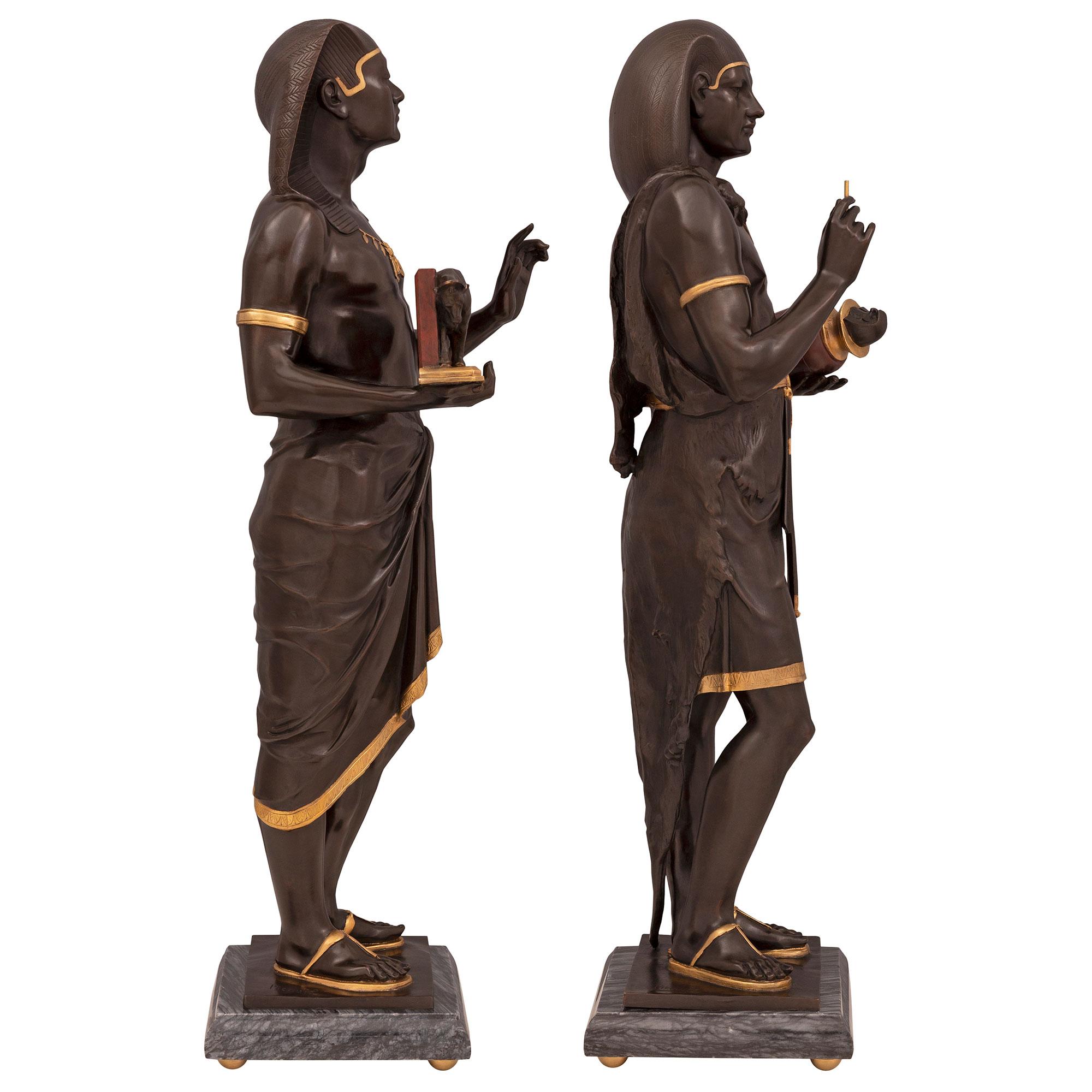 Patinated Pair of French 19th Century Neoclassical Style Egyptian Revival Statues For Sale