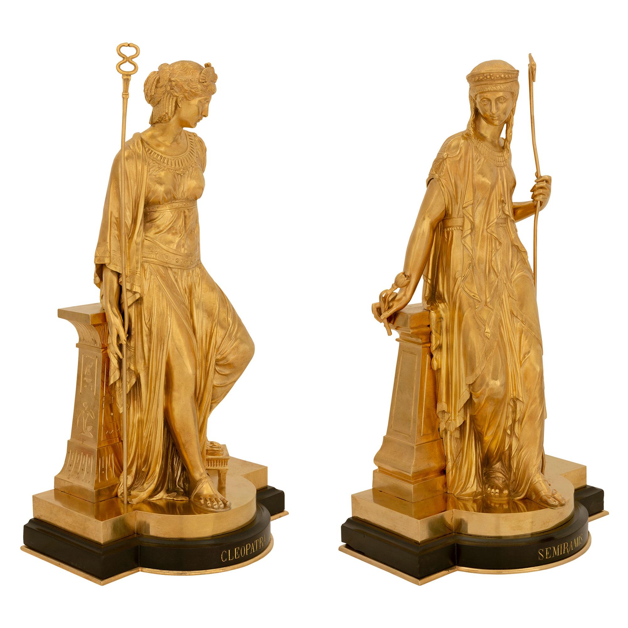 A striking true pair of French 19th century Neo-Classical st. black Belgian marble and ormolu statues of Cleopatra and Semiramis, signed Bouret 1874. Each statue is raised by an elegant black Belgian marble base with a fine bottom ormolu fillet and