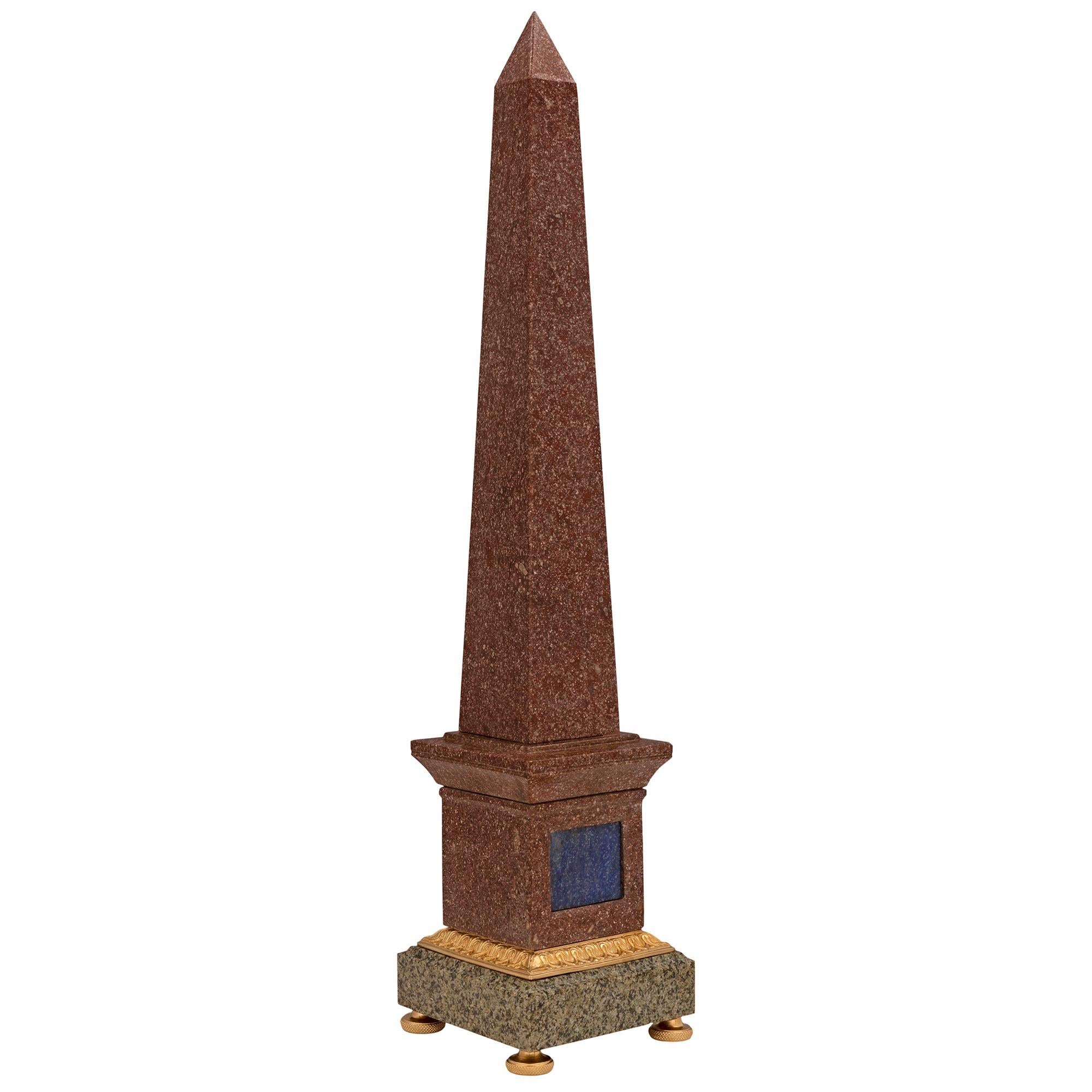 An impressive pair of French 19th century neo-classical st. Porphyry, granite, Lapis Lazuli and ormolu obelisks. Each obelisk is raised by fine ormolu feet below the square green granite base with a mottled border. Above a richly chased wrap around