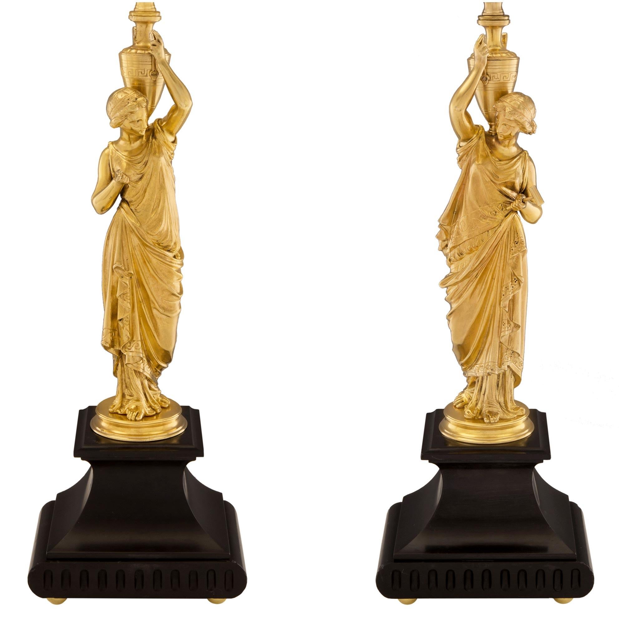 A most elegant and high quality true pair of French 19th century neoclassical St. ormolu and black Belgian marble lamps. Each lamp is raised by a fine and most decorative black Belgian marble base with fine ormolu ball feet, fluted patterns and