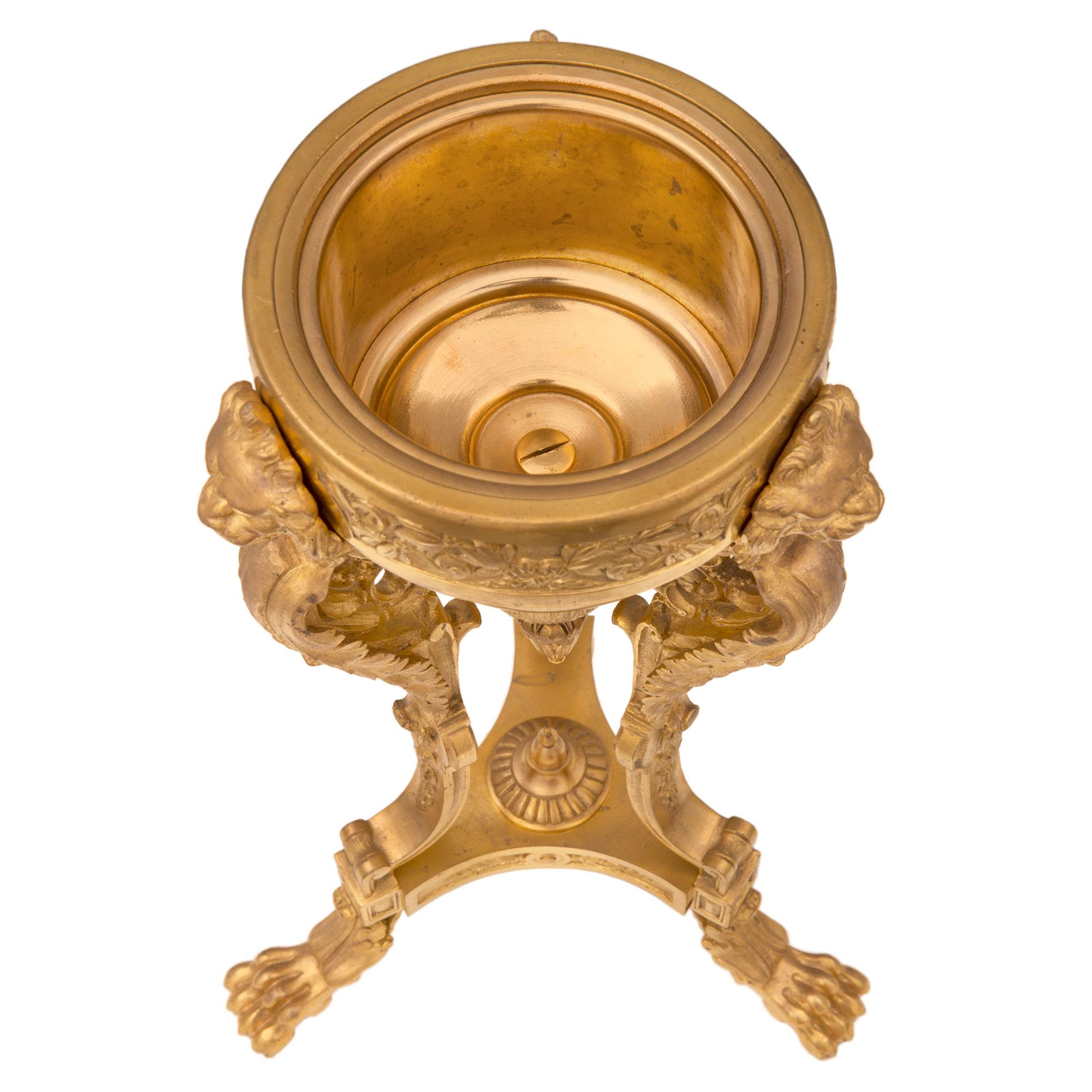 An impressive pair of French 19th century Neo-Classical st. ormolu and Vert de Patricia marble lidded urns. Each urn is raised by three handsome ormolu paw feet with fine acanthus leaves. Above each foot are block reserves centered by elegant