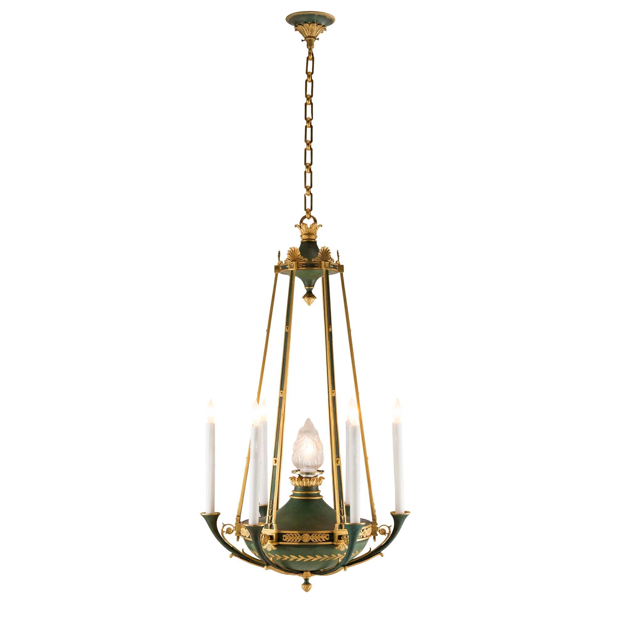 A handsome and extremely decorative pair of French 19th century Neo-Classical st. ormolu and verdigris chandeliers. Each six arm seven light chandelier is centered by a giltwood inverted acorn finial on a verdigris background. The verdigris base