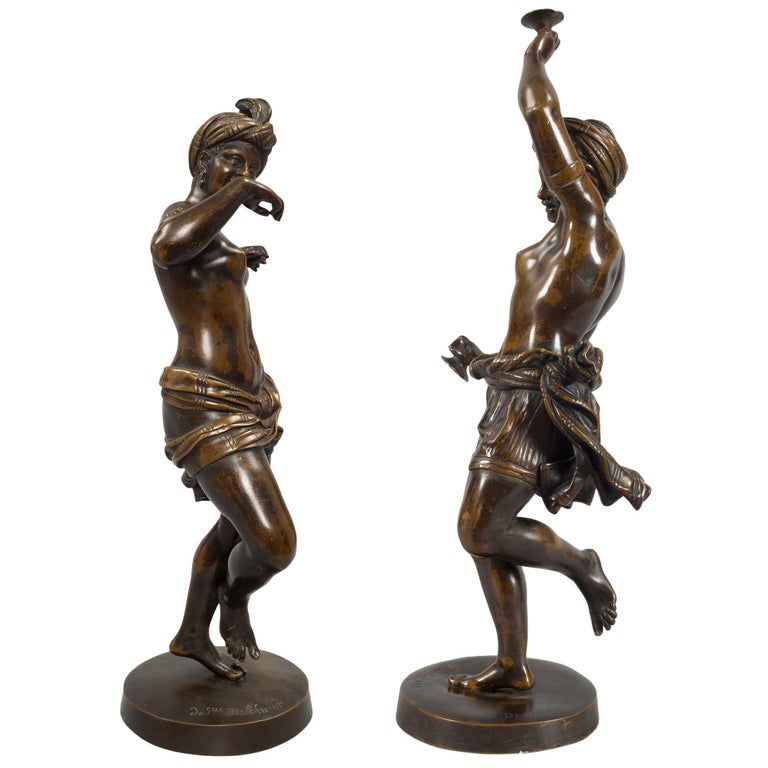 A high quality true pair of French 19th century neo-classical st. patinated bronze statues, signed DENIERE. Each statue is raised by a circular base where the signature as well as an inscription are displayed. The statues above are of joyously