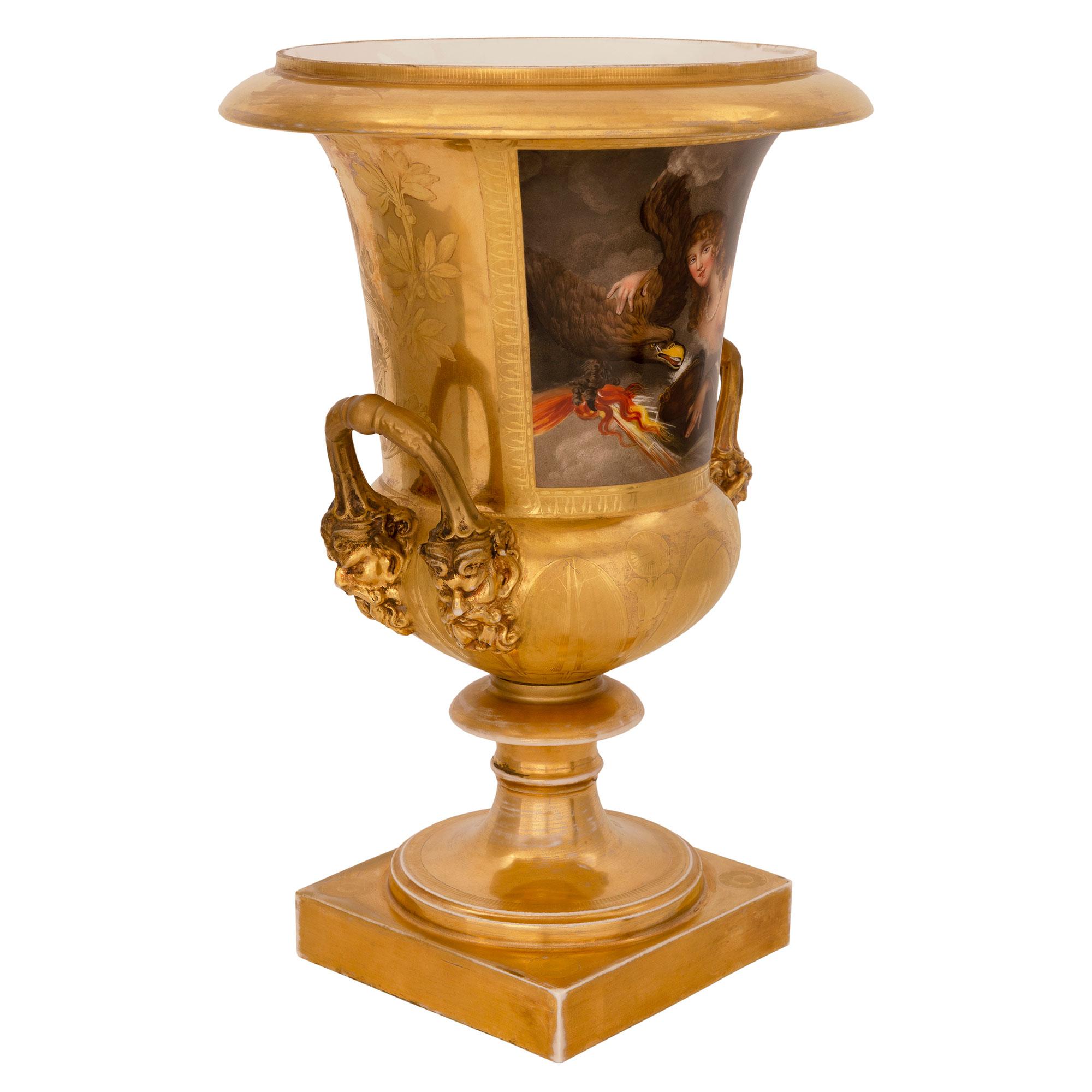 A most elegant pair of French 19th century neo-classical st. Porcelain de Paris urns. Each urn is raised by a square base below an elegant mottled socle shaped pedestal. The bodies display lovely finely etched gilt leaves with striking bearded satyr