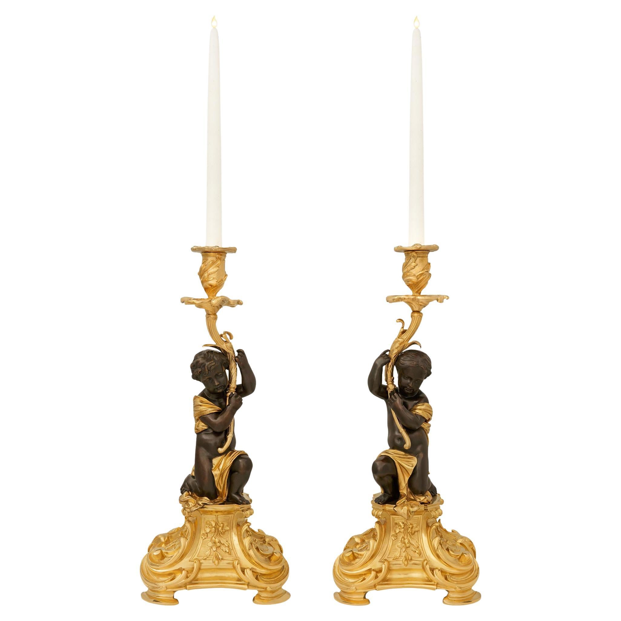 pair of French 19th century Ormolu and Bronze candlesticks, by Picard For Sale