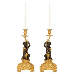 pair of French 19th century Ormolu and Bronze candlesticks, by Picard