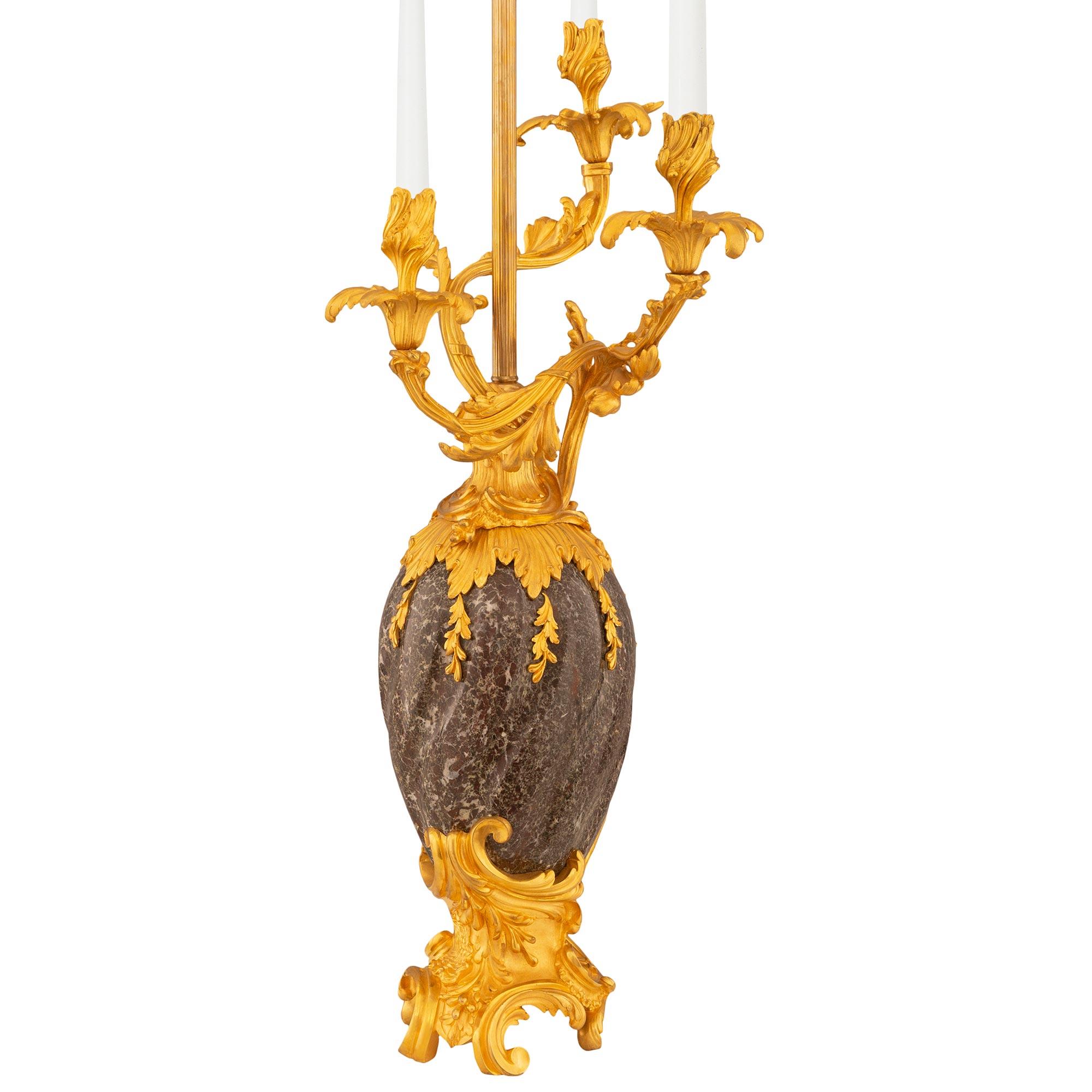 An impressive and palatial pair of French 19th century Louis XV st. Ormolu and Rosso Levanto marble candelabra lamps. Each stunning and high quality lamp is raised on an Ormolu Rocaille designed base with scrolled movements and block feet supporting