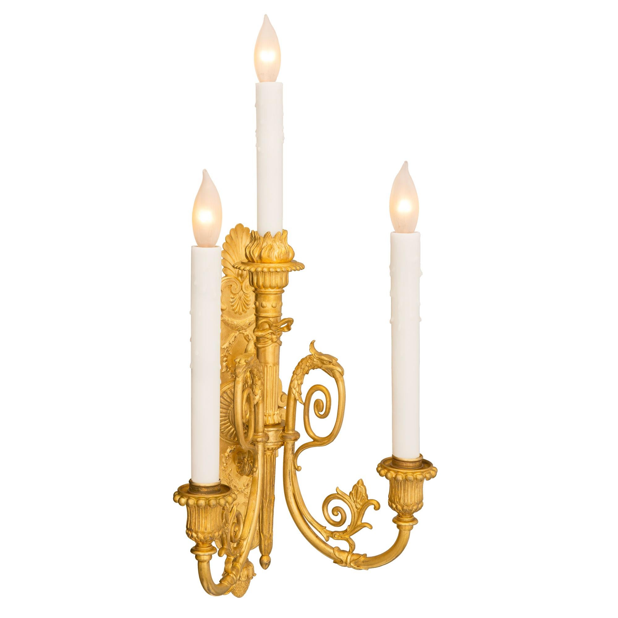 An elegant and high quality pair of French 19th century Neo-Classical st. ormolu sconces, signed F. Barbedienne. Each three arm sconce is centered by a lovely bottom acorn finial below fine scrolled foliate designs at the back plate. The central