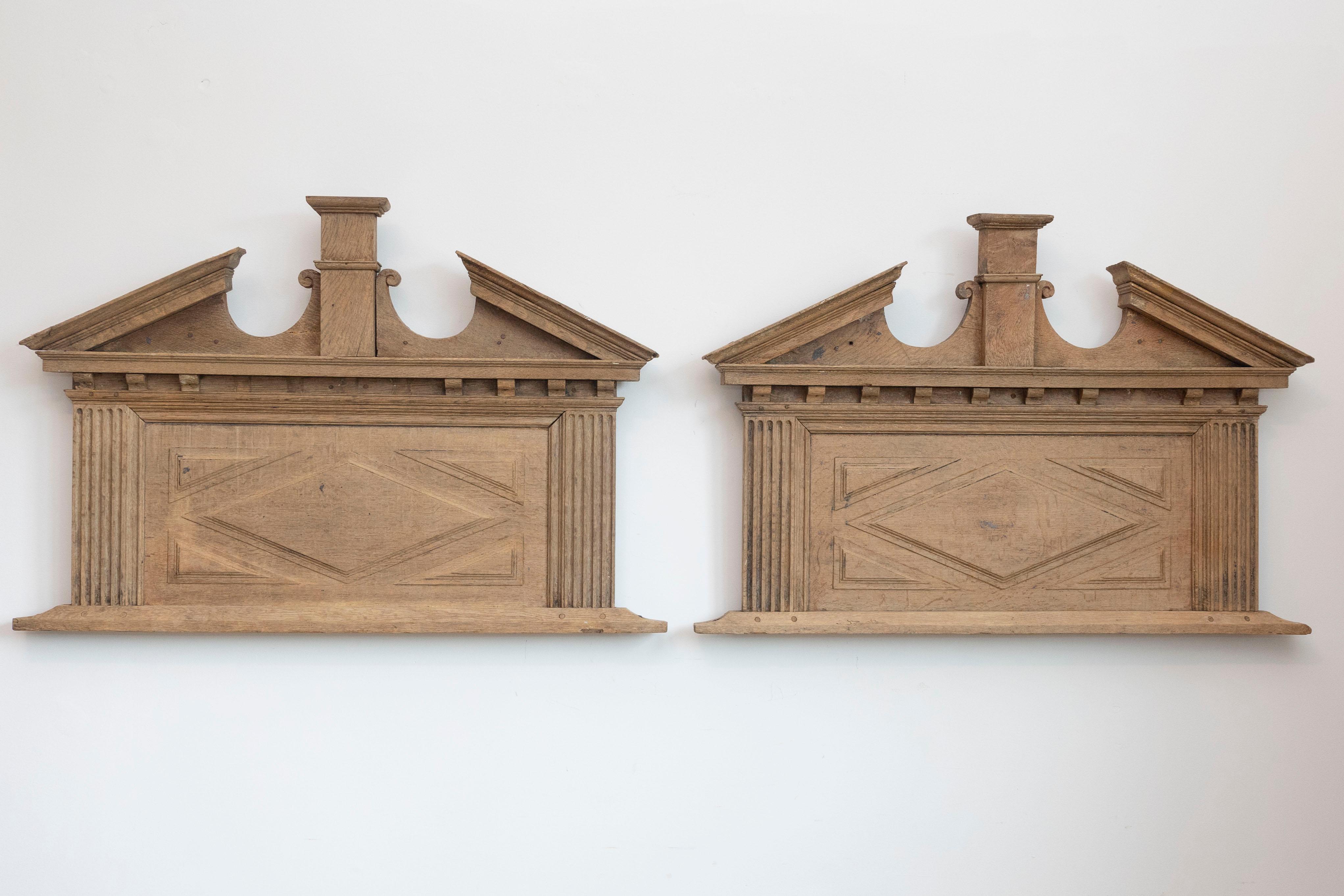 Pareja de sobrepuertas francesas del siglo XIX, con frontones rotos, pilastras y motivos acanalados. Creadas en Francia durante el siglo XIX, cada una de este par de sobrepuertas capta nuestra atención por su frontón roto marcado con una pilastra