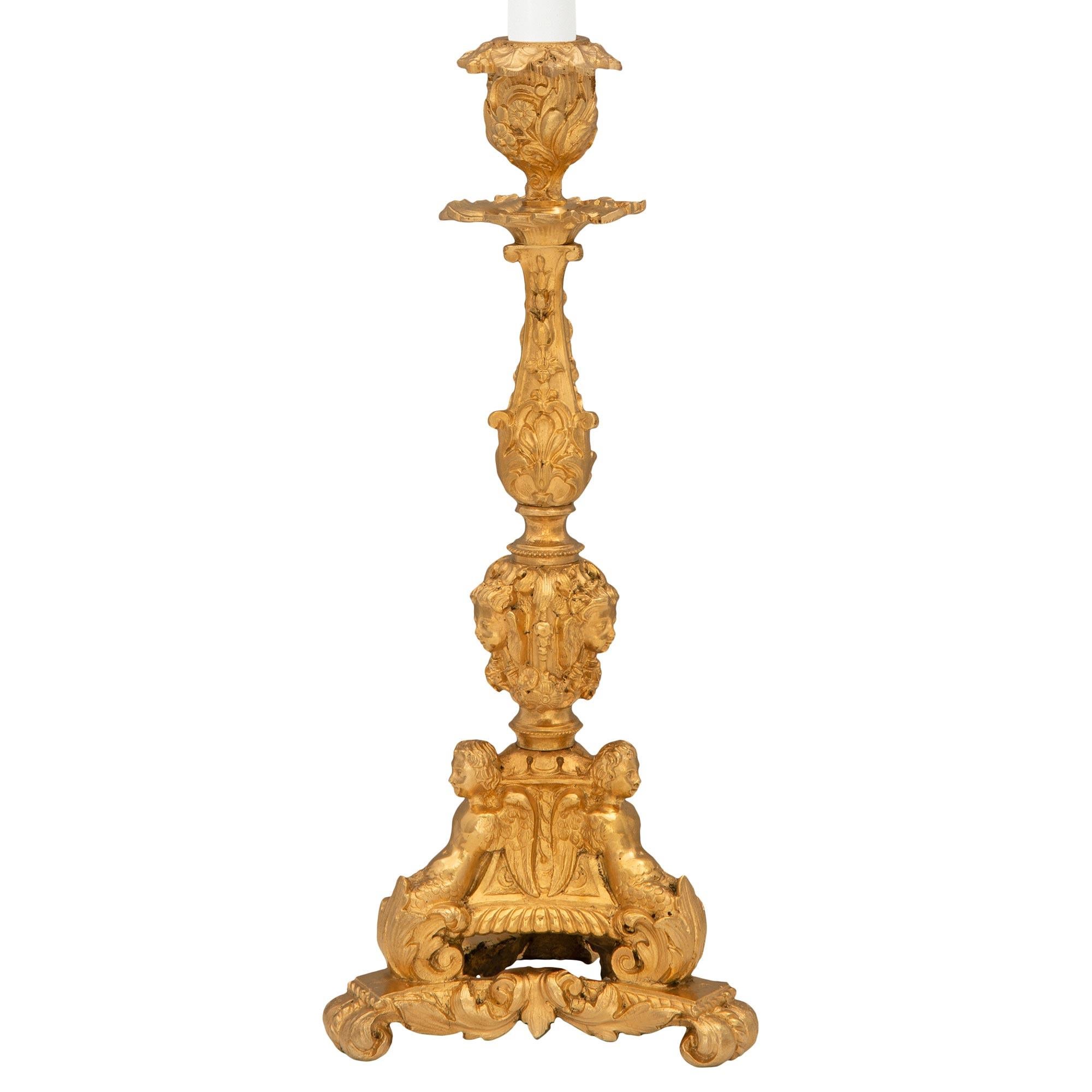 An exceptional pair of French 19th century Renaissance st. ormolu candlesticks. Each candlestick is raised by an elegant and most decorative triangular base with lavish scrolled foliate designs and three richly chased personages below beautiful
