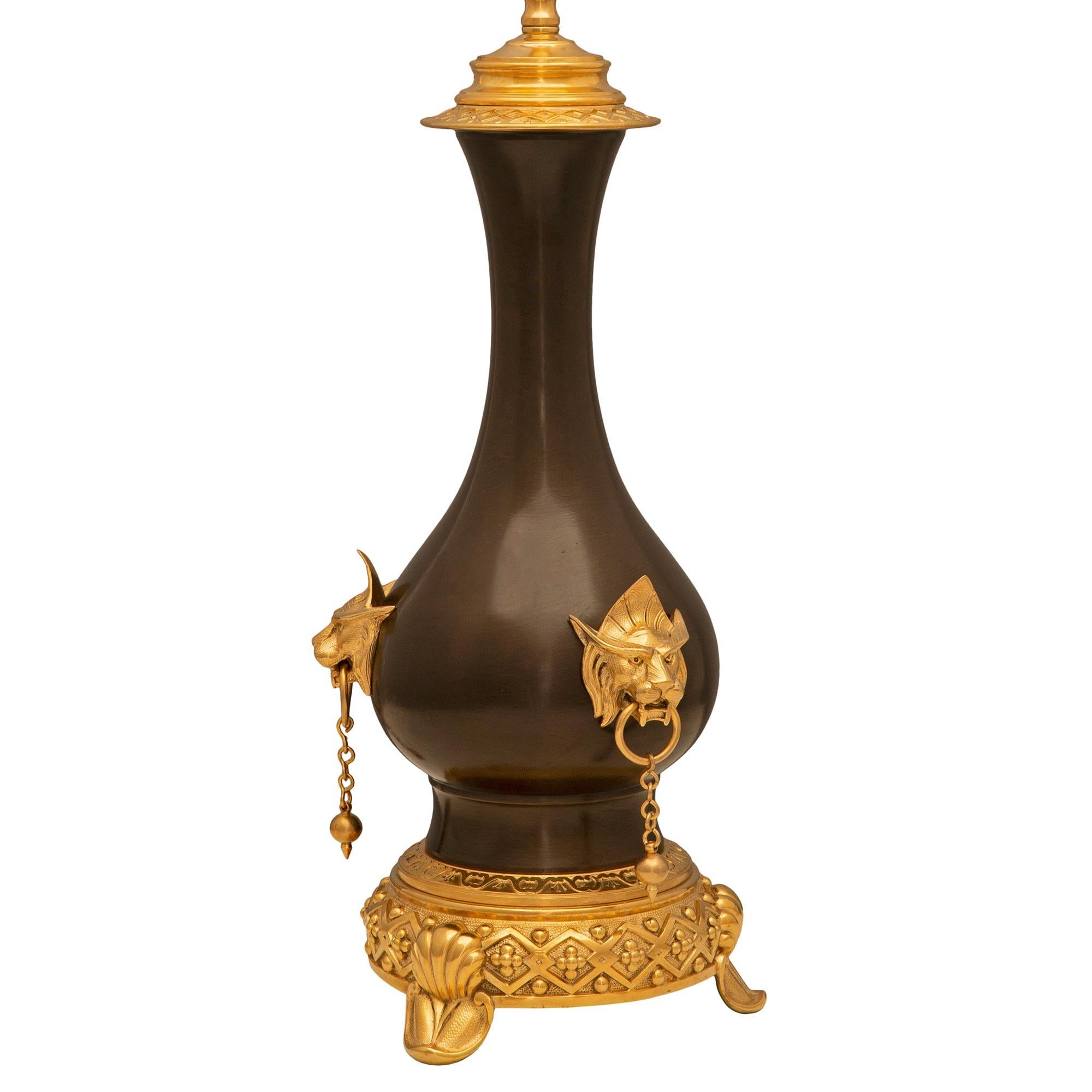 Une remarquable paire de lampes françaises du 19ème siècle de style Renaissance en bronze patiné et bronze doré. Chaque lampe est surélevée par une belle base circulaire avec trois supports en forme de coquillage et un magnifique et unique bandeau
