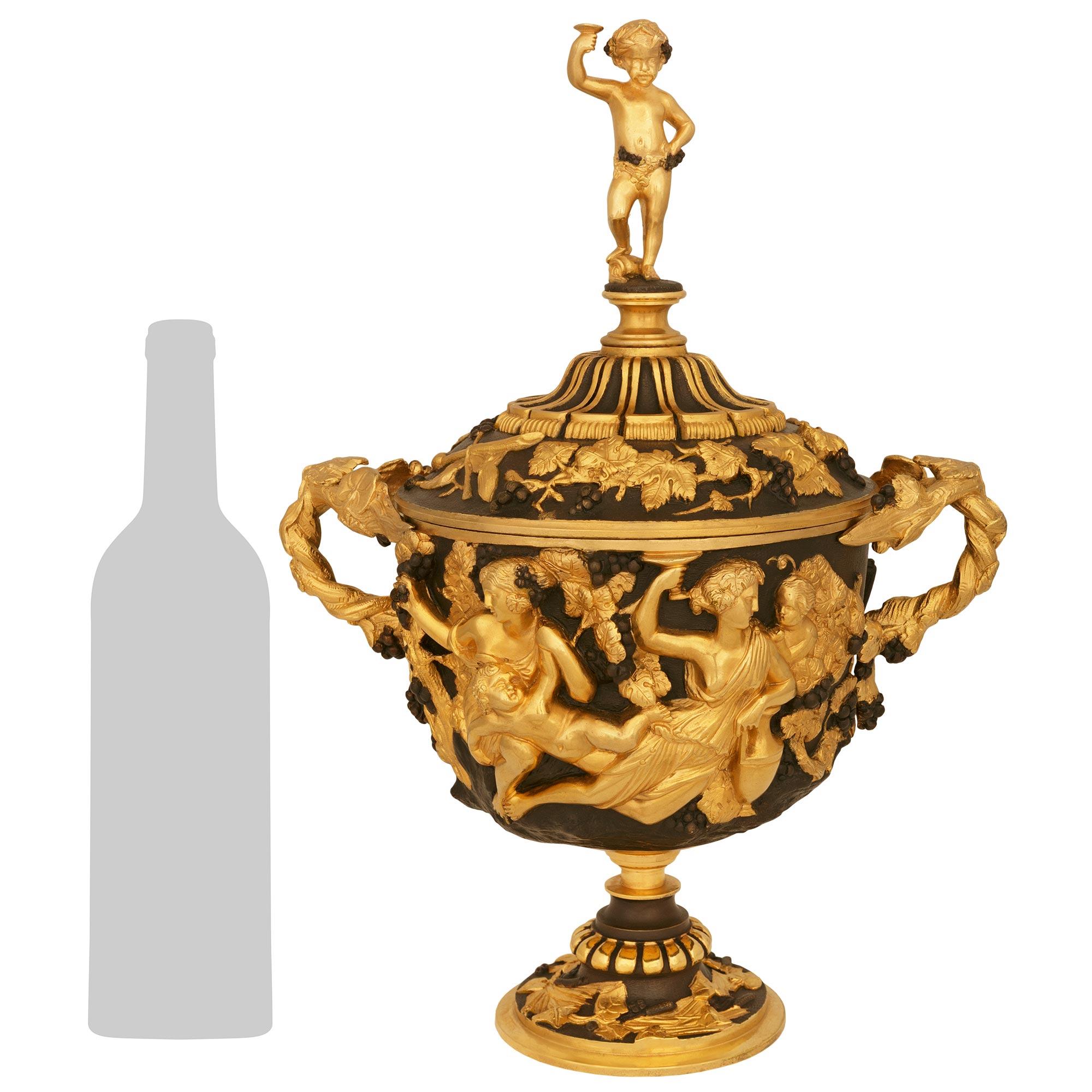 Une paire d'urnes en bronze patiné et bronze doré de la Renaissance française du 19e siècle. Cette magnifique paire d'urnes à couvercle repose sur des bases circulaires avec un bandeau extérieur en bronze doré et un feuillage sur fond de bronze