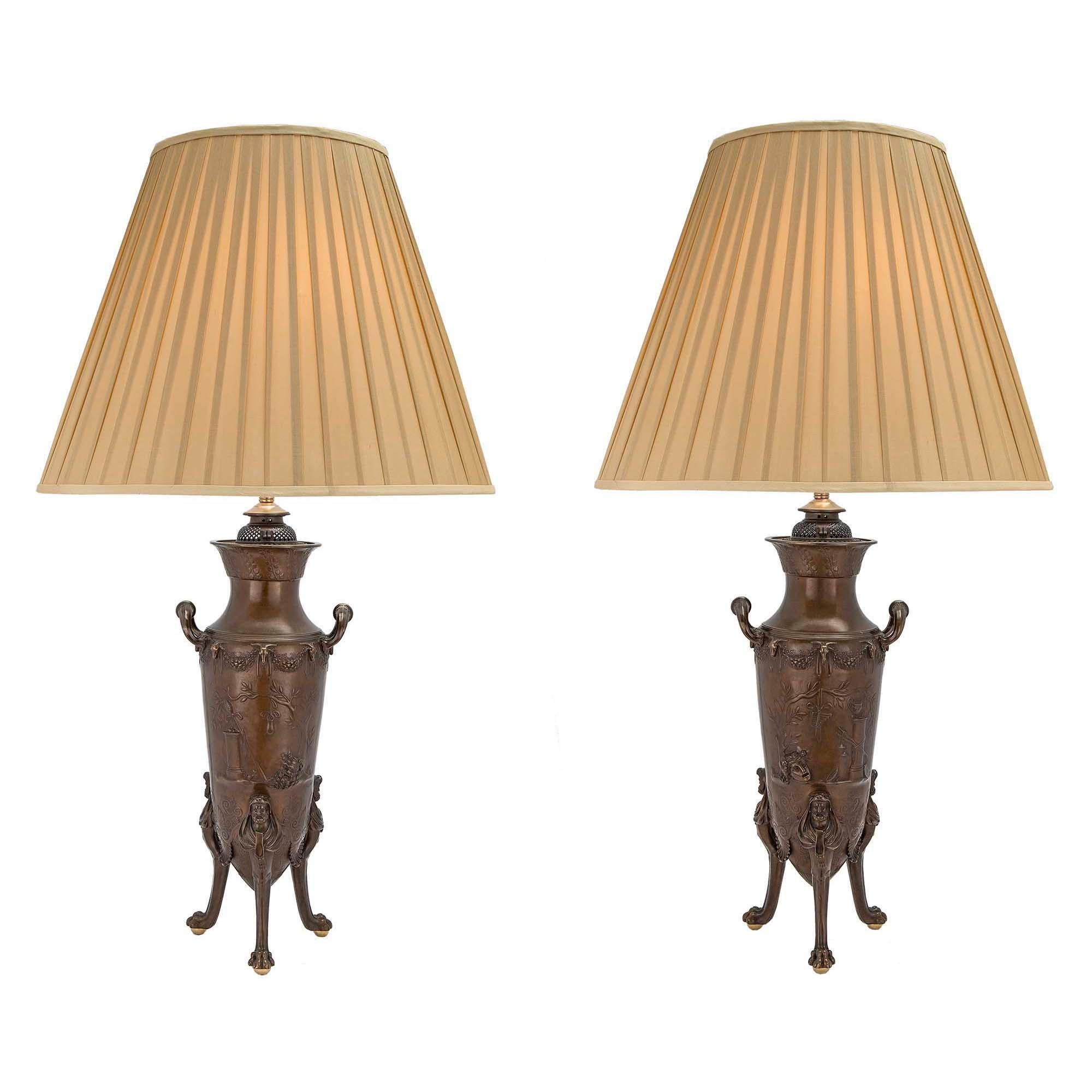 A handsome and unusually larger scale true pair of French 19th century Renaissance st. patinated bronze lamps signed F. Levillain & F. Barbedienne. Each lamp is raised by a tripod with fine paws holding ormolu ball feet and Hercules wearing lion