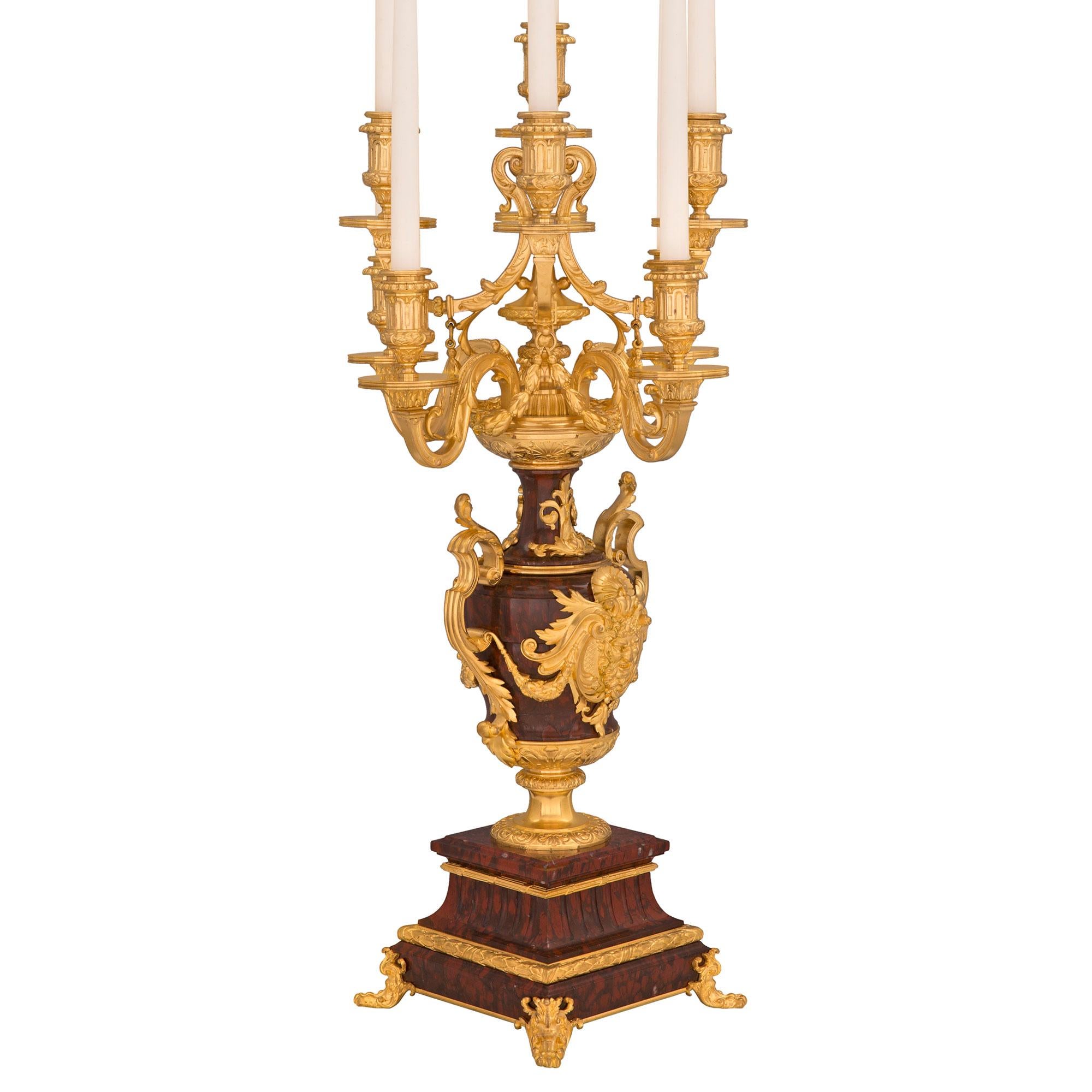 A superb quality and impressive large scale pair of French 19th century Renaissance st. Rouge Griotte and ormolu nine arm candelabras, signed F. Barbedienne. Each is raised by a square Rouge Griotte marble base with an ormolu ‘C’ scrolled support in
