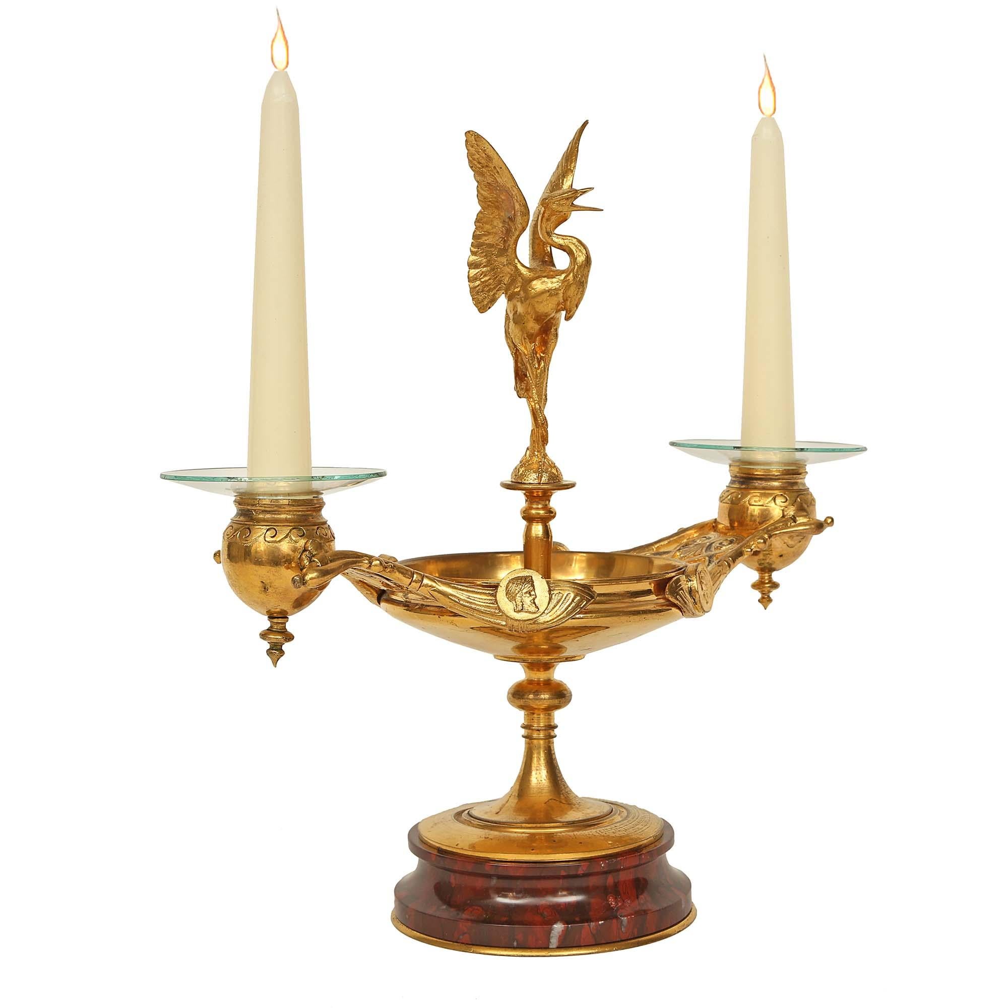 A stunning pair of French 19th century Renaissance st. ormolu and marble candelabras. Each candelabras is raised by a circular moulded Rouge Griotte marble base with a bottom decorative ormolu band. Above the elegant socle pedestal is a bowl with a
