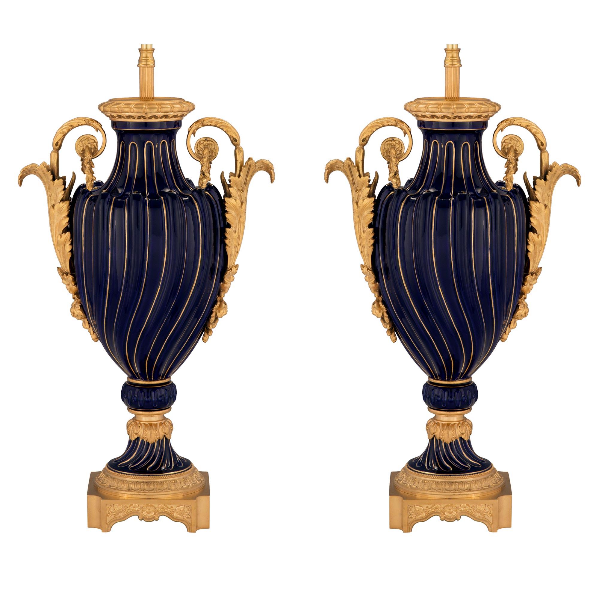 An elegant and high quality pair of French 19th century cobalt blue Sèvres porcelain and ormolu mounted lamps. Each lamp is raised by a fine square ormolu base with concave corners and charming foliate movements below an egg and dart ormolu pattern.