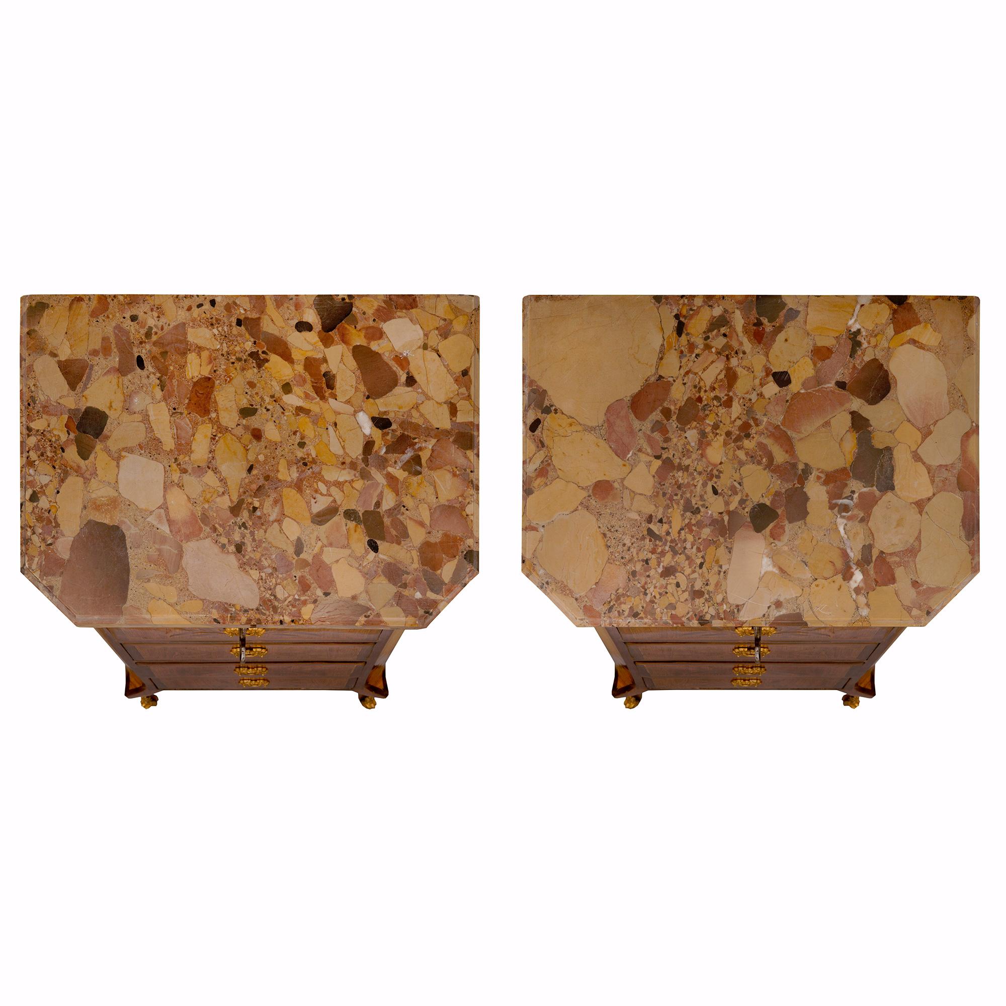 An elegant and small scale pair of French 19th century Transitional st. tulipwood, charmwood, ormolu and Brèche d'Alep marble chiffonier cabinets. Each five drawer cabinet is raised by fine cabriole legs with foliate ormolu sabots. At the center are