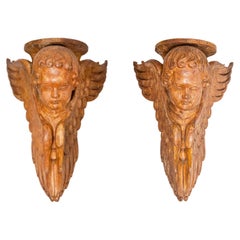 Pair of French 19th Century Wooden Wall Brackets with Carved Cherubs