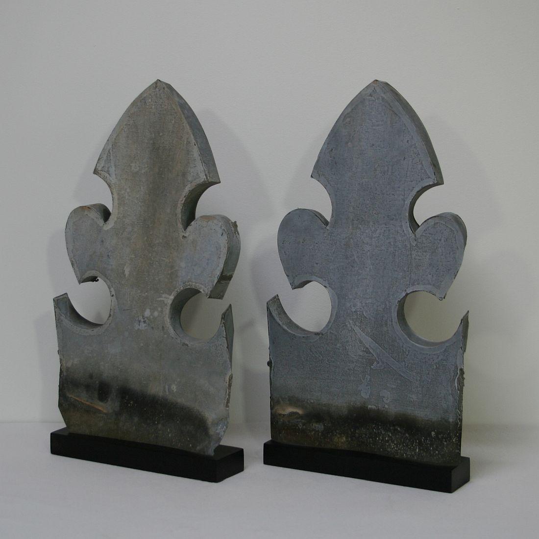 Great pair of zinc finials, France, circa 1880. Weathered, small losses. Measurement individual and includes the base.