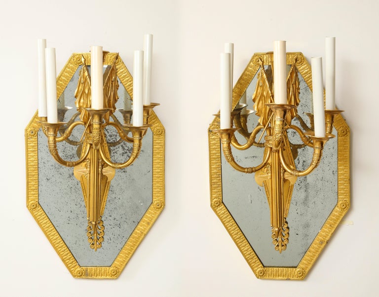 A Magnificent Pair of French 1st Empire Period Dore bronze mounted five-arm sconces/mirrors, Attributed to Pierre-Philippe Thomire. Each mirrored sconce is of octagonal form with a beautiful antique, original, mirrored backing on a dore bronze