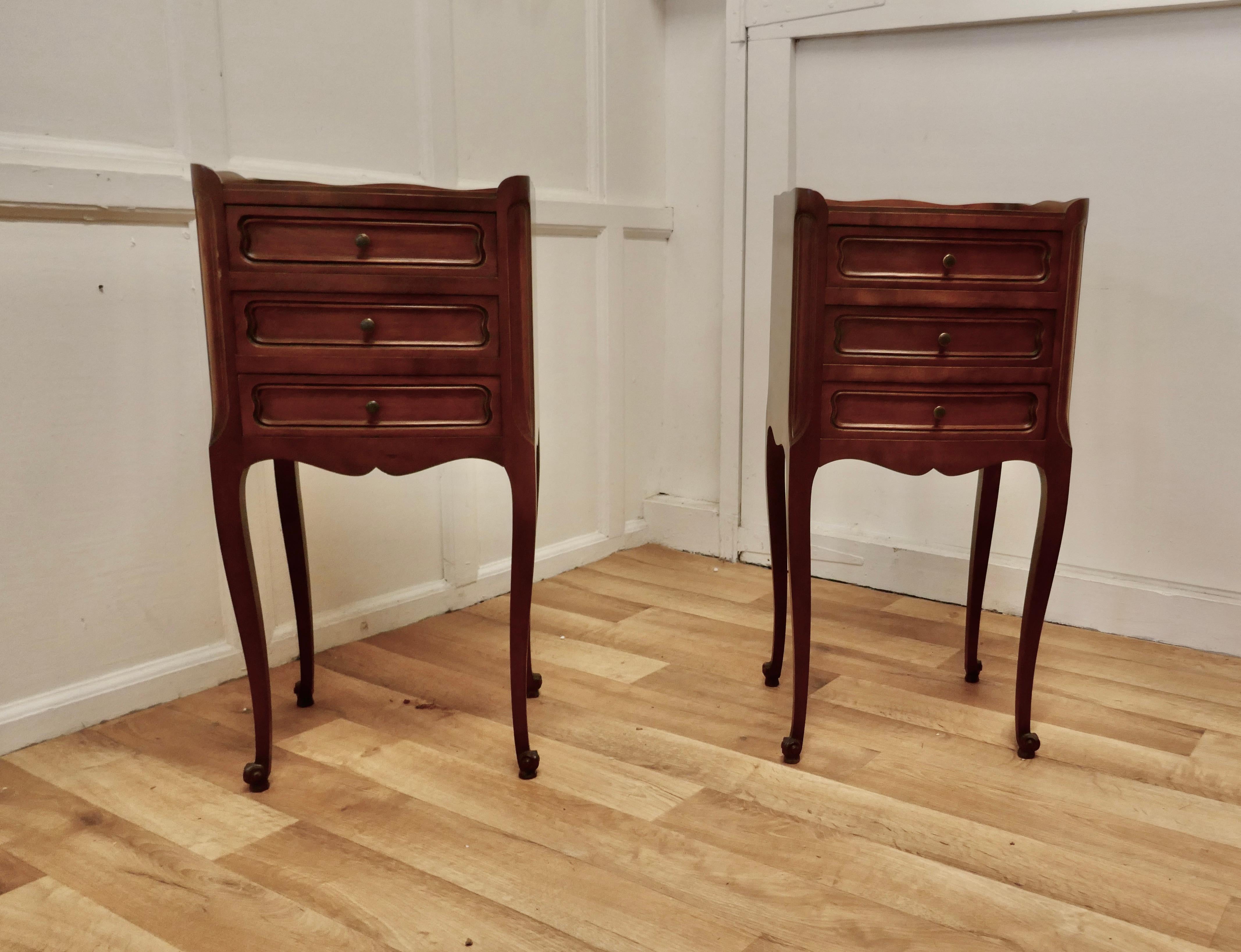 Pair of French 3 Drawer Cherry Wood Bedside Cabinets 

This is a pretty pair of cabinets or chevets, they have a small gallery around the top and stand on slender cabriole legs
Each Cabinet has 3 drawers 
The Cabinets are in good condition, they