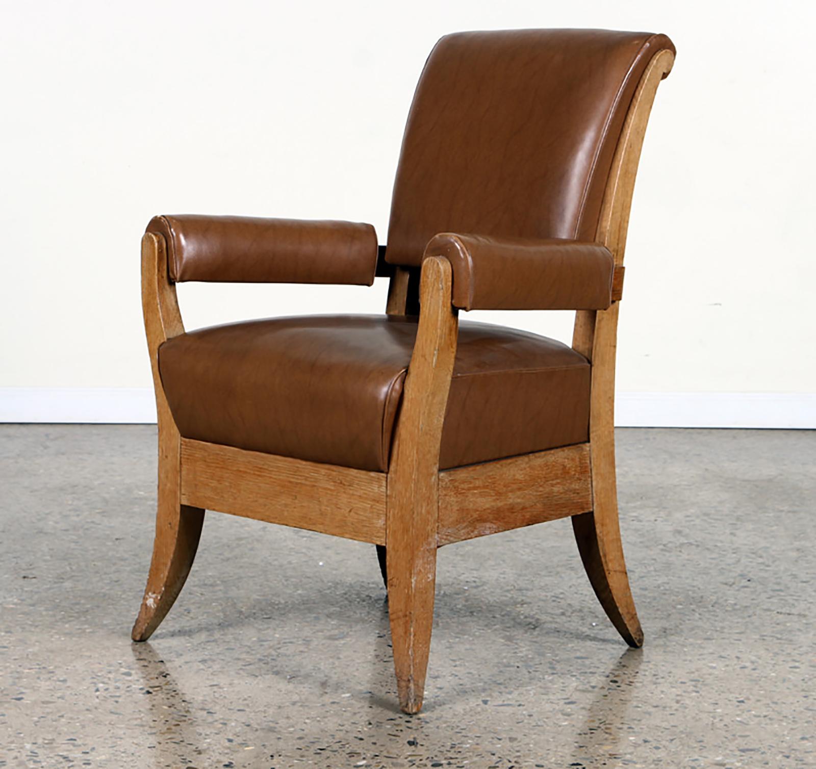 Pair of French 1940s leather upholstered oak armchairs.