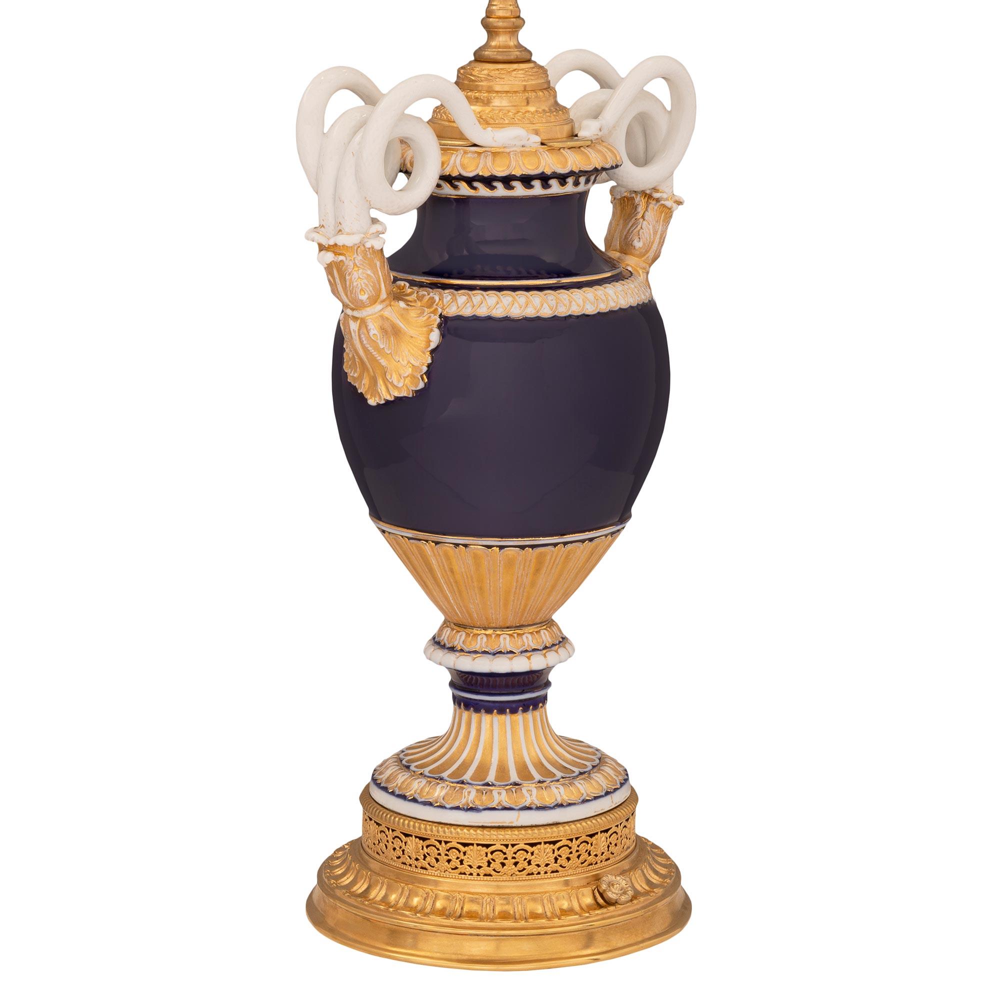 A lovely pair of French and German collaboration 19th century Meissen porcelain and ormolu urns mounted into lamps. Each beautiful lamp is raised by a most elegant circular base with a reeded wrap around band below a lovely intricately pierced
