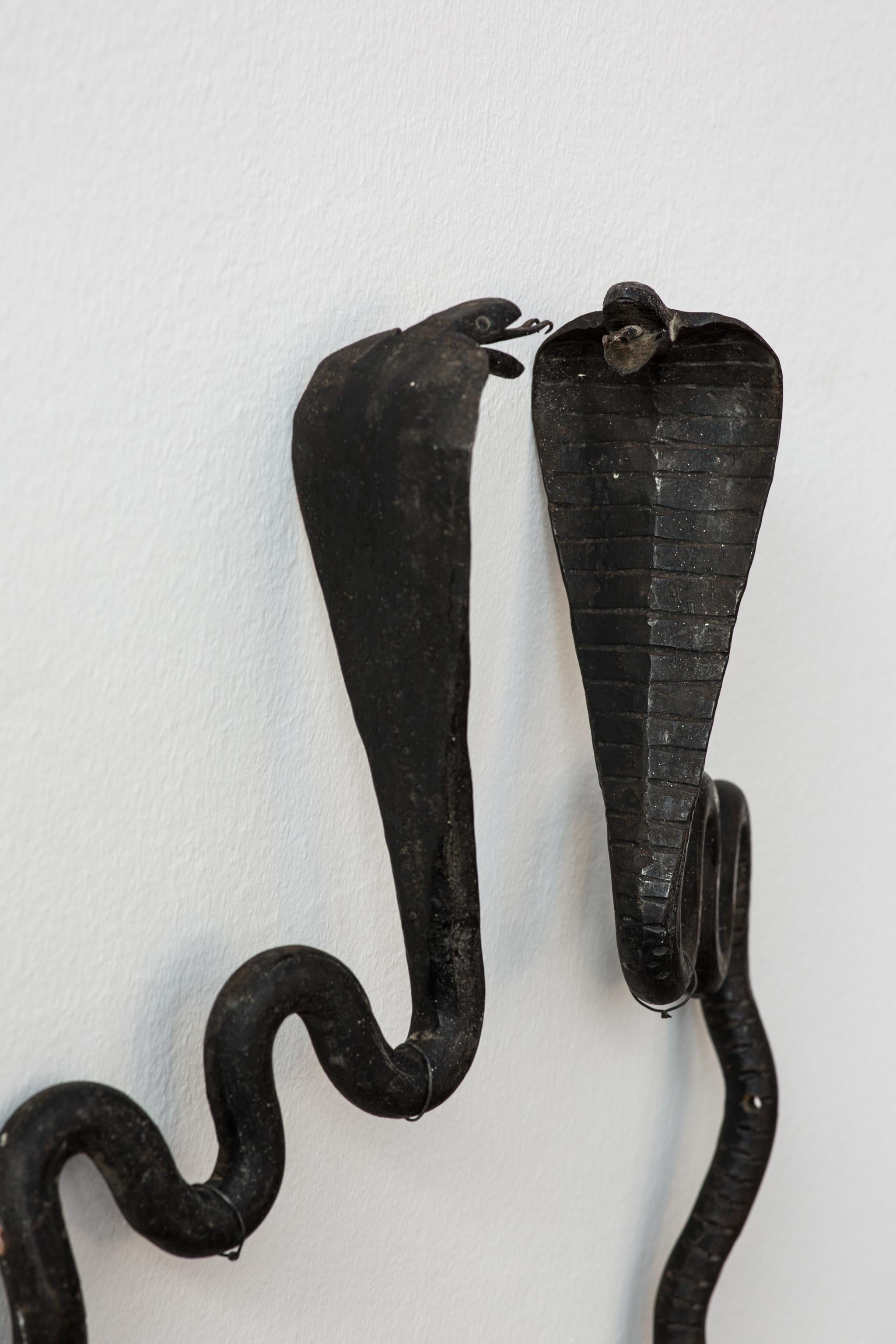 Very unusual and unique Pair of Art Deco iron Wall lights in the shape of snakes from France. The snakes are made from Black Wrought Iron in France at the beginning of the 20th Century and were more likely used as wall appliques in former times.