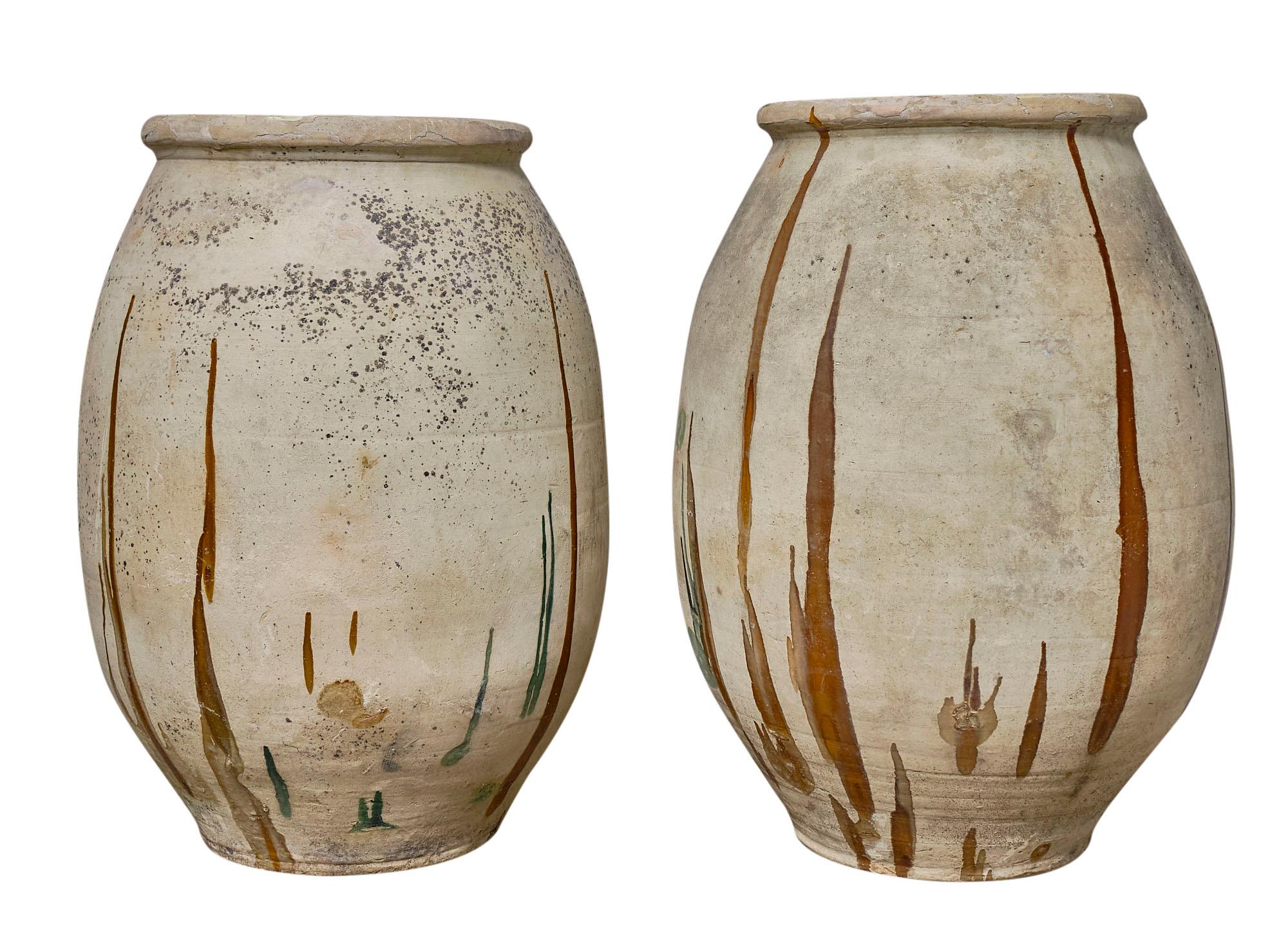 These antique Biot pots of considerable size will lure in any view! Originally used to hold oil; the interiors of the pots are glazed with the signature color of the region of origin in Southern France. The original glaze is still in great shape and