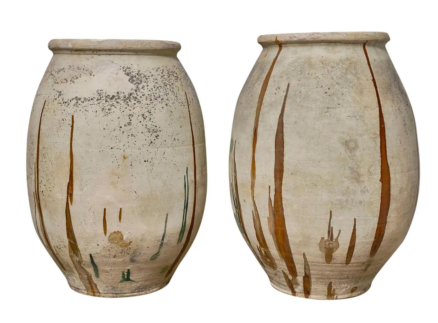 Indulge in the allure of these expansive antique Biot pots, once vessels of precious oils. Adorned with an interior glaze reflecting the distinctive palette of Southern France, these pots boast impeccably preserved original finishes. A splendid