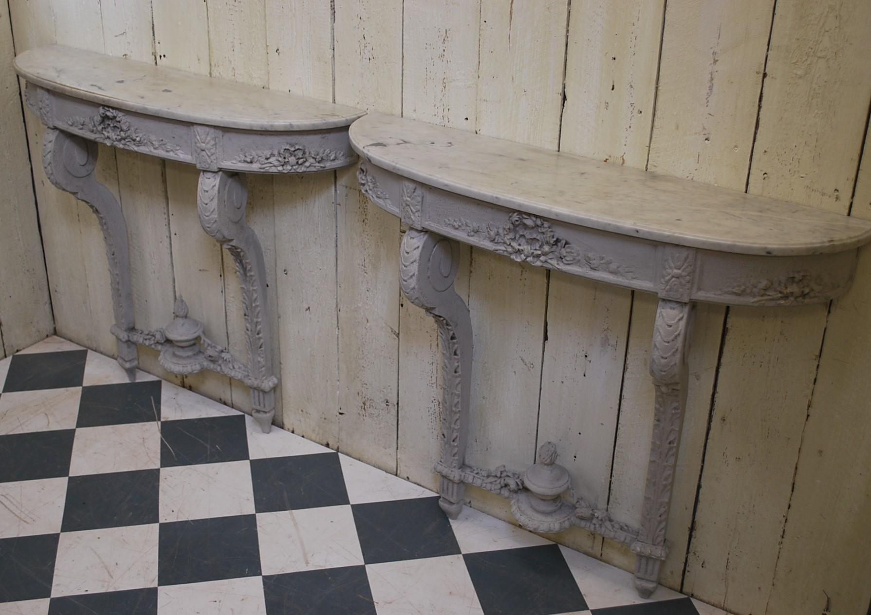 An unusual pair of French console tables with original Carrera marble tops. Decorated in grey paint of foiage and classical motifs.
Pairs of decorative consoles are always hard to find and these are a nice example.