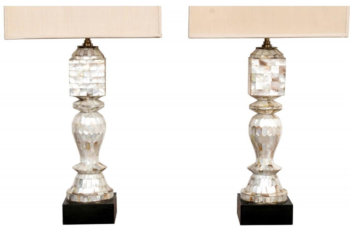 Pair of tessellated mother of pearl baluster form French antique table lamps with mosaic veneers and mounted on a black plinth base. Covered with rectangular hardback shade, adjustable finial rod. From Eric Appel, circa 1900.
Dimensions: 28 1/2