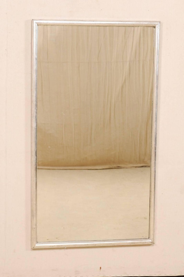 Pair of French Antique Five Foot Tall Mirrors with Elegant Silver