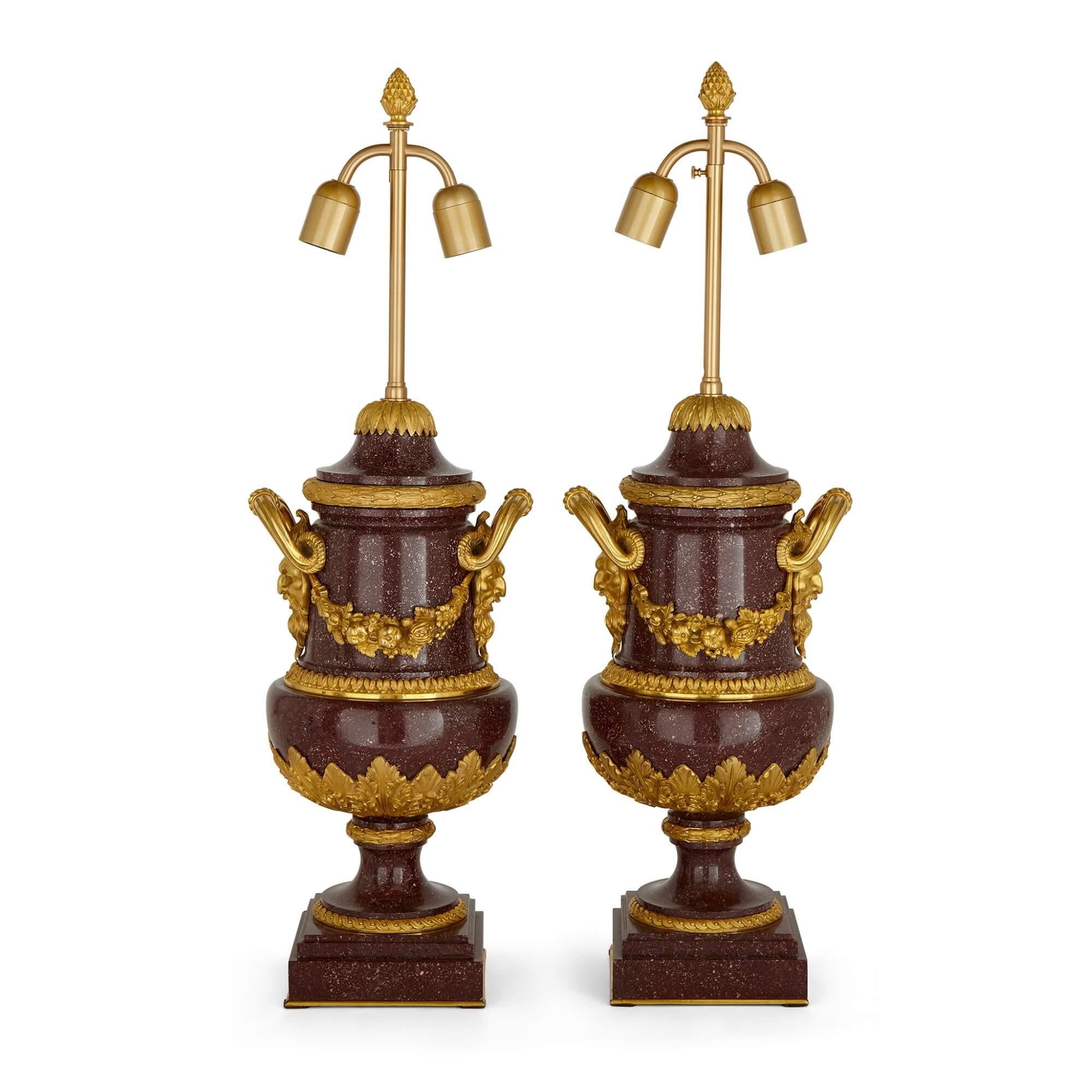 Pair of French antique gilt bronze and porphyry lamps 
French, Late 19th Century 
Lamps: Height 87 (tallest) / 75cm (shortest), diameter 21cm
Shades: Height 32cm, diameter 50cm

This wonderful pair of vases was made in late 19th century France from